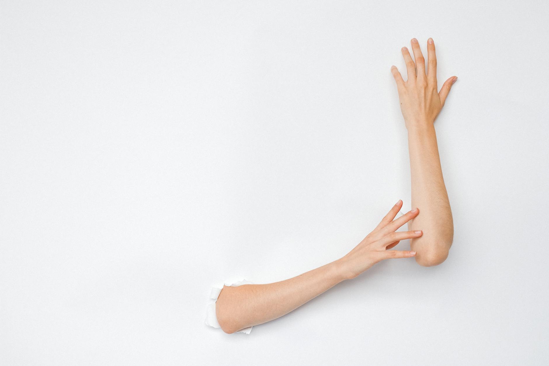A creative and artistic image of hands extending from a hole in a white wall, highlighting human expression. - spring break family boundaries