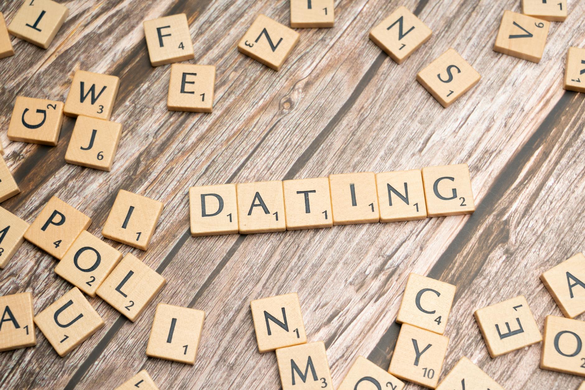 Scrabble tiles forming 'Dating' on a wooden background, representing relationships. - spring dating tips