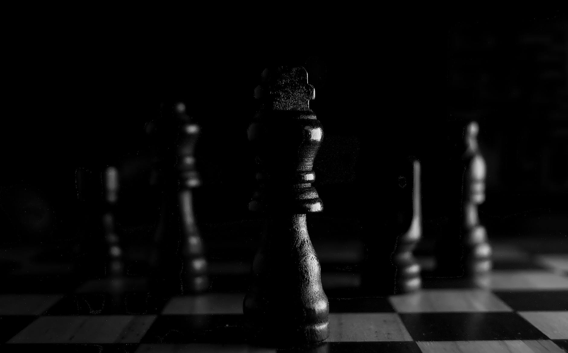 Strategic close-up of chess pieces on a board, highlighting the queen in black and white. - spring mental reset