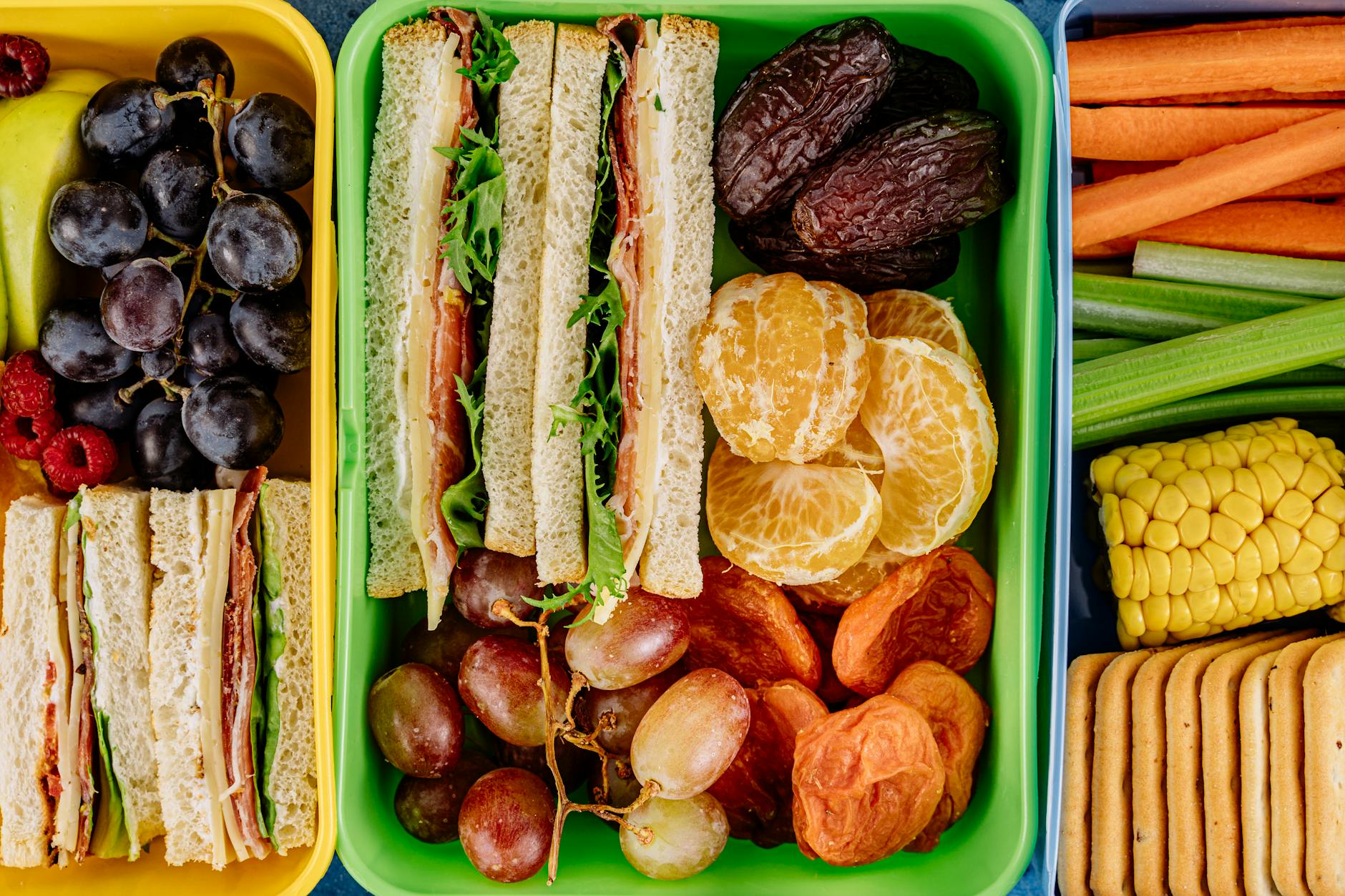 Colorful lunchbox filled with sandwiches, fresh fruits, and vegetables, perfect for a healthy meal. - spring outdoor date ideas