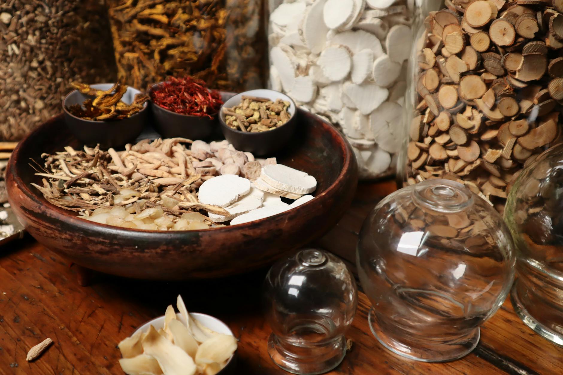 A collection of dried herbs and ingredients used in traditional medicine, displayed in a rustic setting. - spring slump remedies