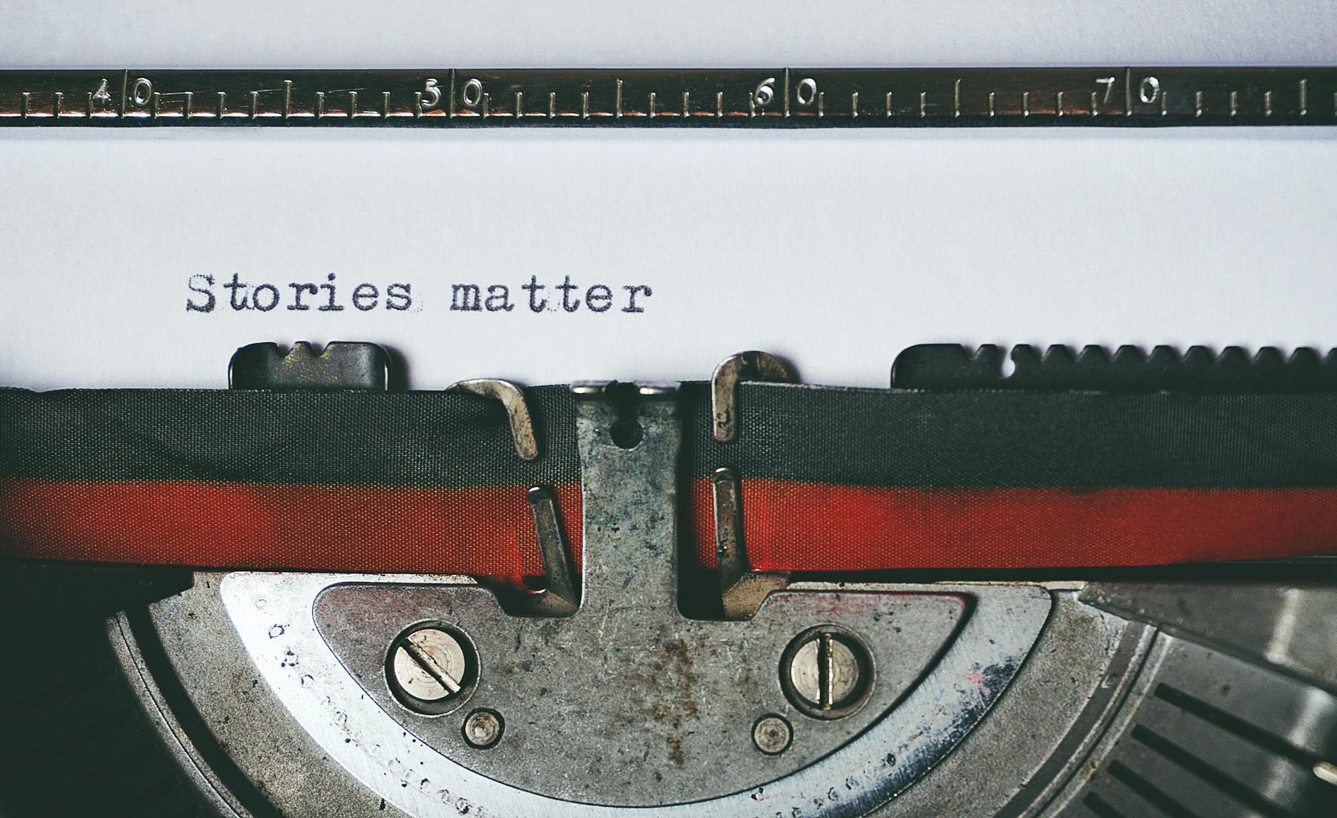 Close-up of a vintage typewriter with the text 'Stories matter' typed on paper, evoking nostalgia. - story resolution meaning