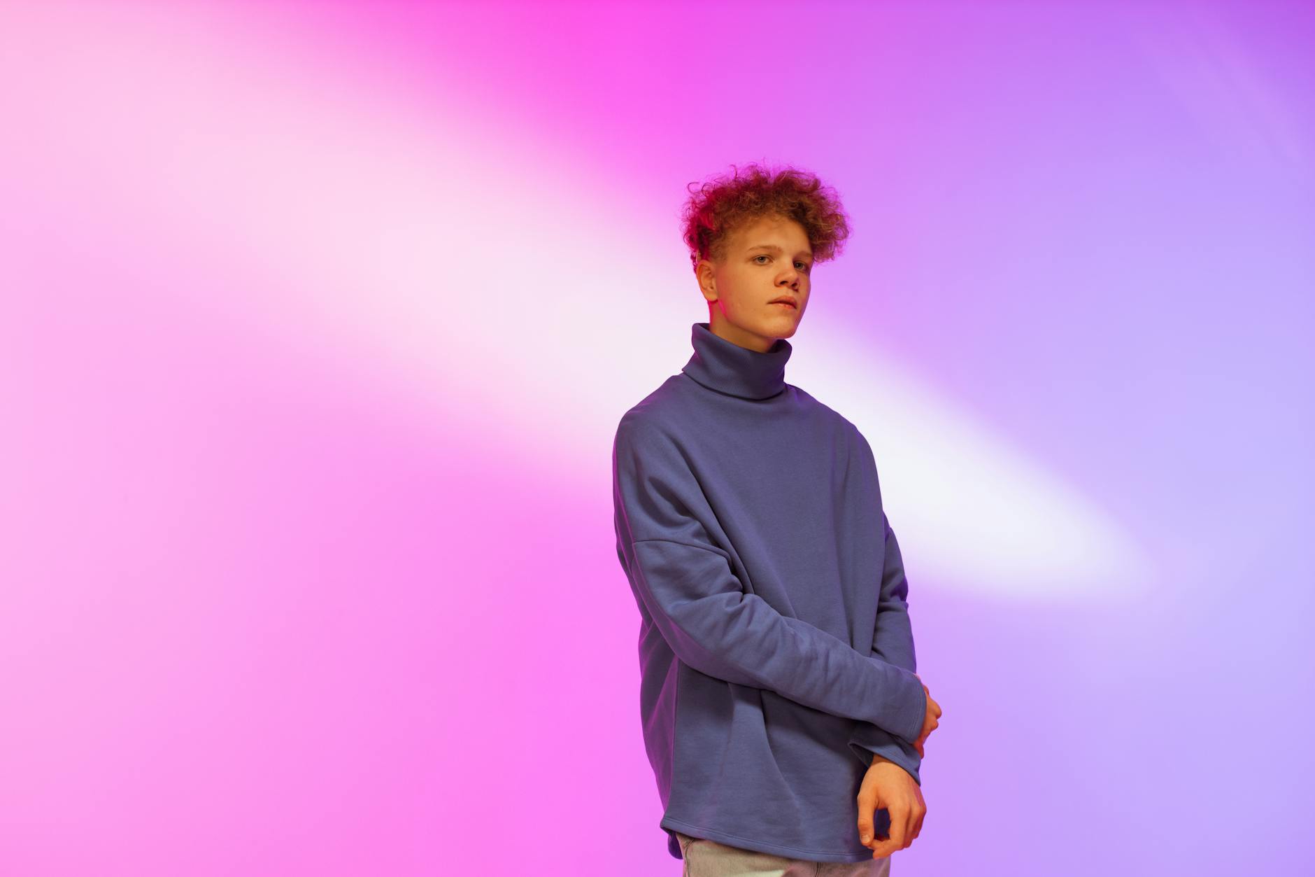 Teen in stylish blue sweater with creative lighting backdrop. - teen winter blues
