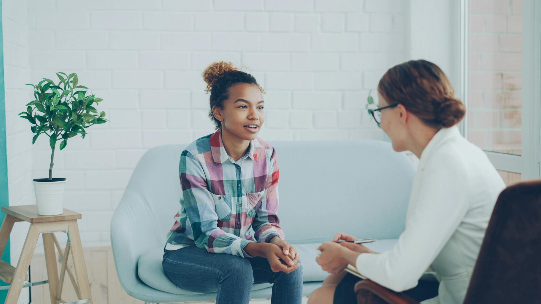 Teenager and therapist in a calm counseling environment. - therapist for depression