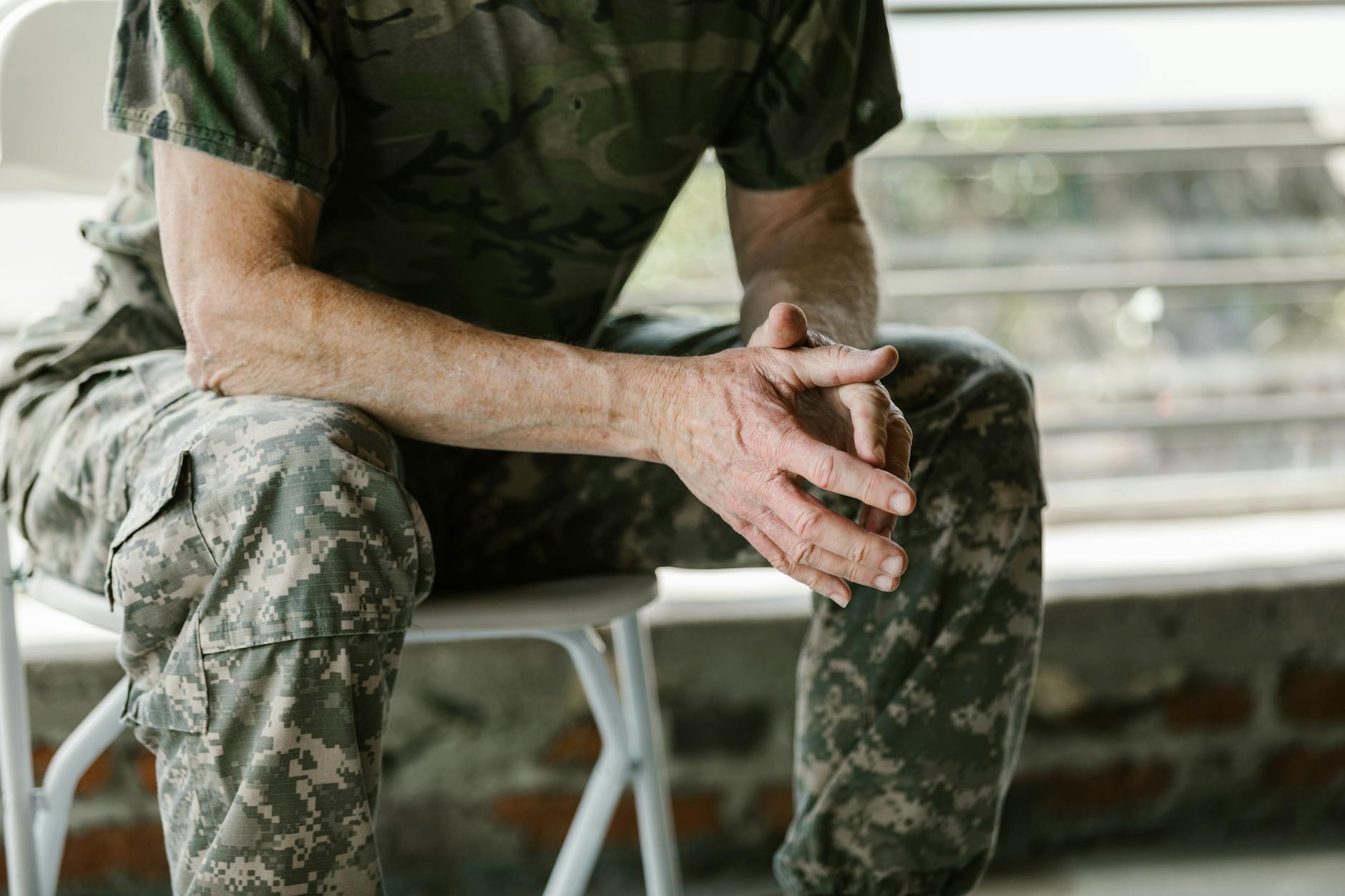 Close-up of a military veteran's hands in a therapy session, emphasizing mental health support. - therapist for seasonal anxiety