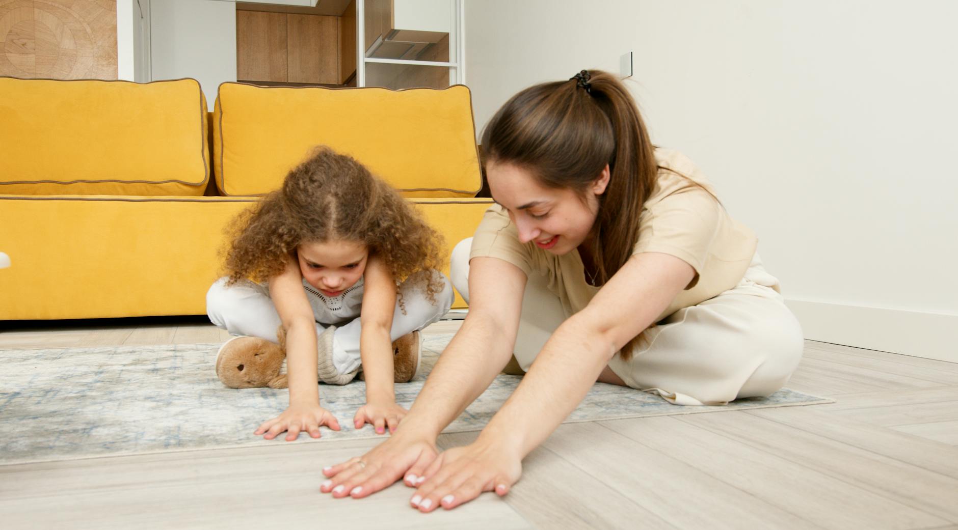 A mother and child practicing yoga exercises together indoors, smiling and bonding. - toddler spring tantrums