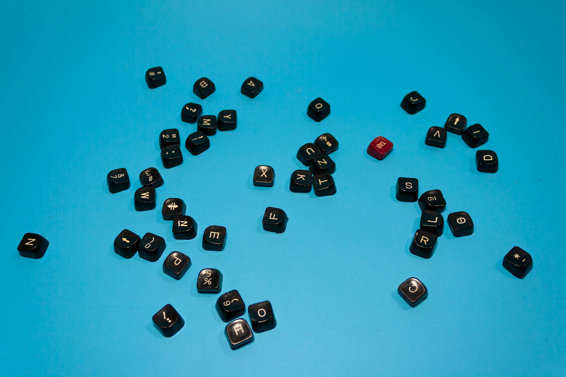 Black keyboard keys scattered on a vibrant blue surface, ideal for tech-themed designs. - types of anxiety disorders