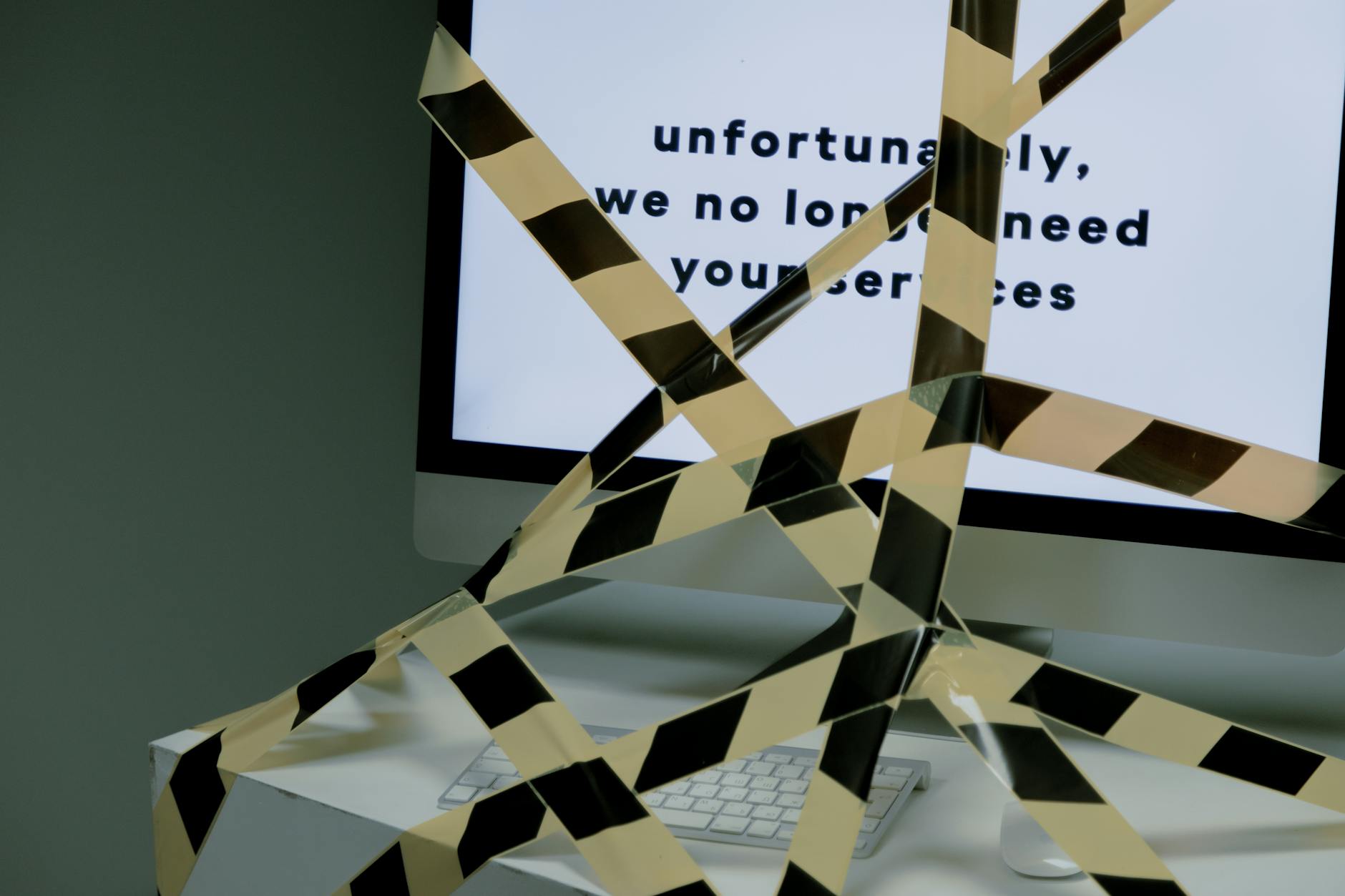 A computer screen taped and displaying a termination message, symbolizing unemployment. - workplace dating policy