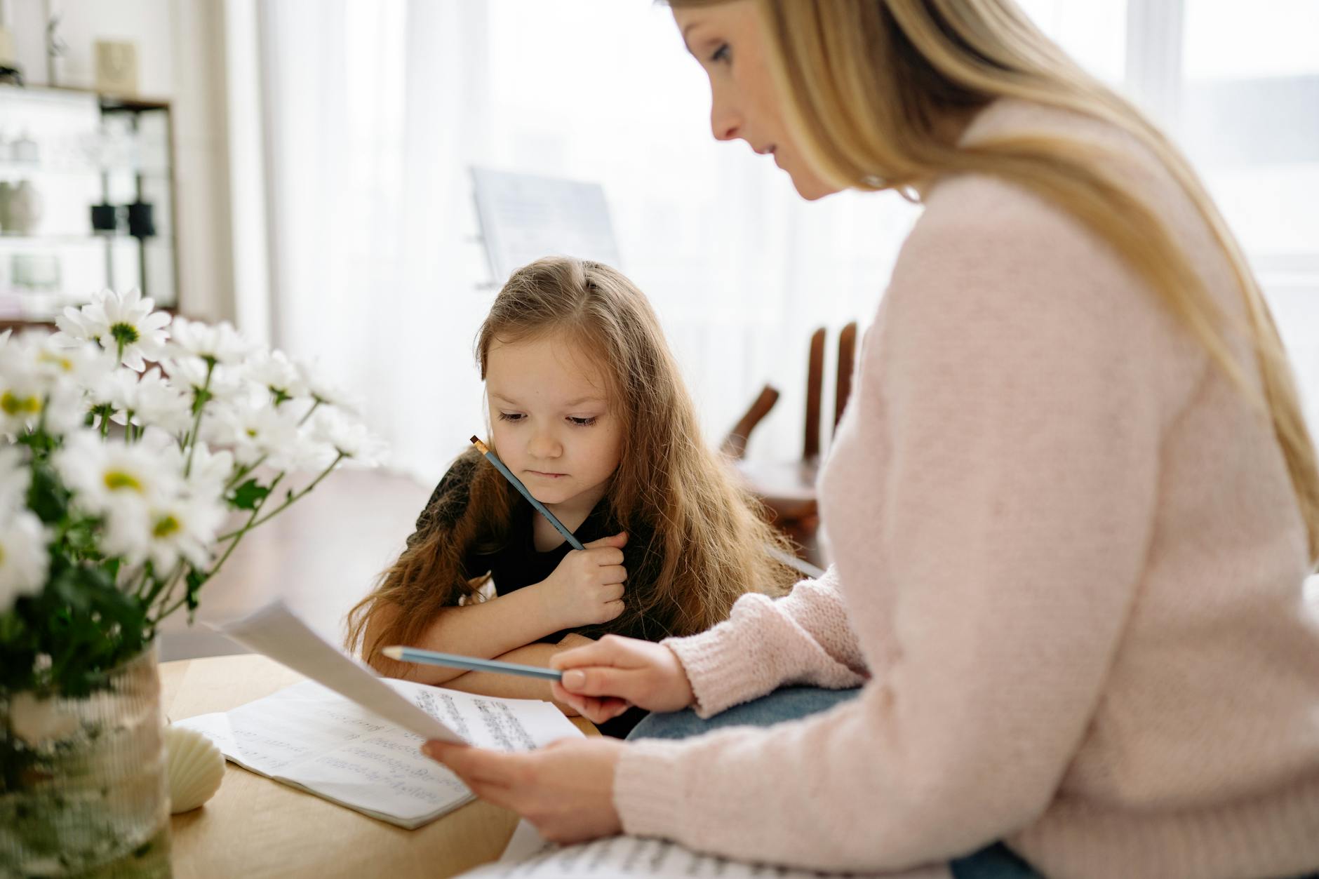 A mother and daughter learning piano together at home, fostering musical education and bonding. - active listening kids