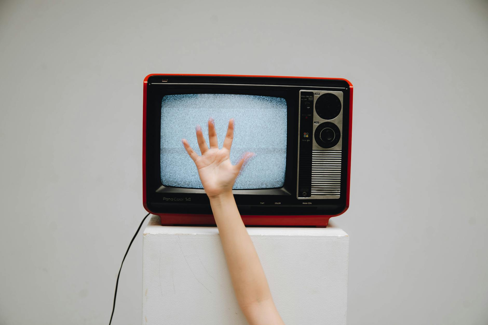 A classic retro television displaying static with a hand reaching towards the screen. - anger management tv shows