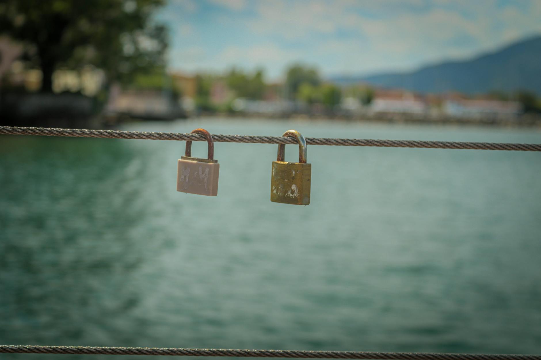 A pair of love padlocks on a railing, symbolizing enduring romance against a serene water backdrop. - attachment styles explained