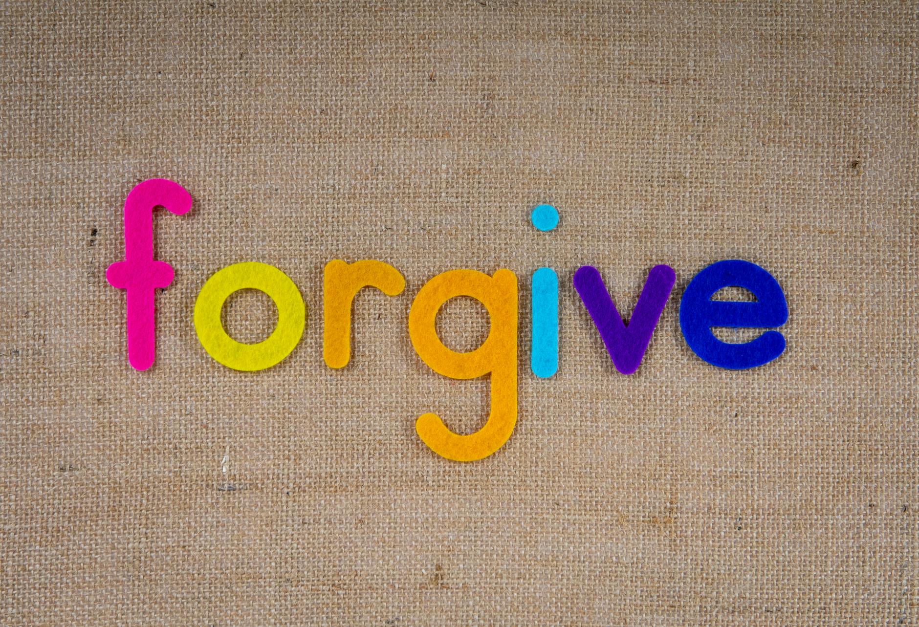 Vibrant felt letters spelling 'forgive' on a burlap background. - bad apology examples