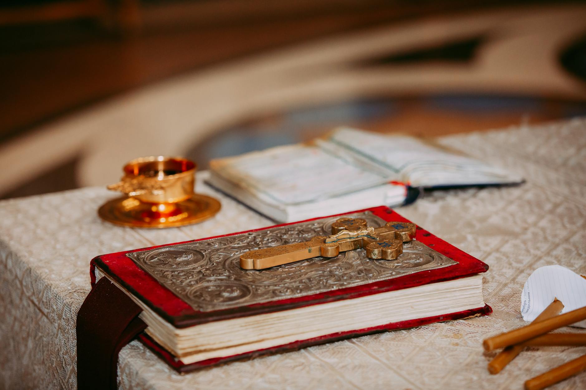 An ornate book with a cross placed on an altar, symbolizing faith and spirituality. - biblical marriage advice