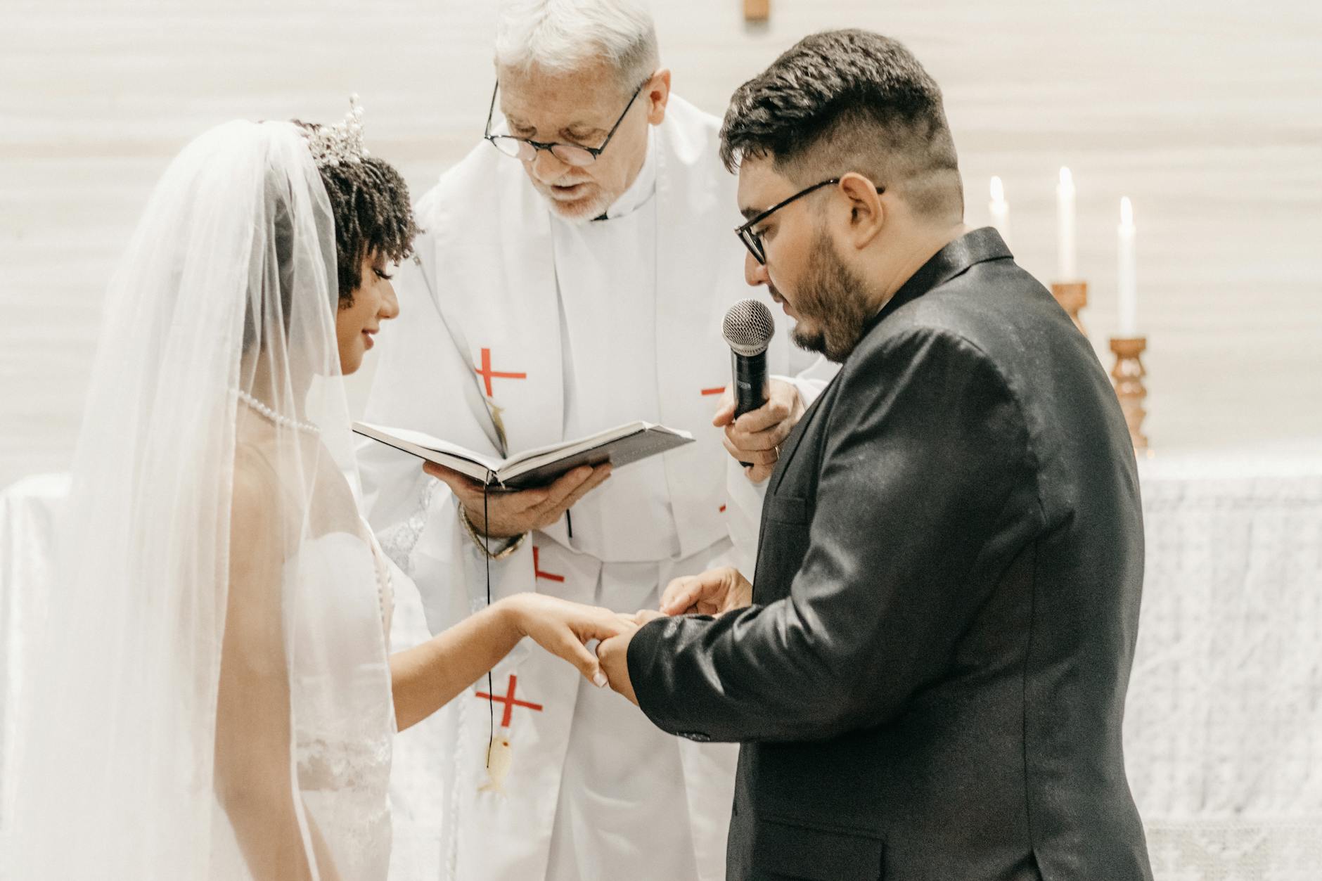 Bride and groom exchanging vows in a church ceremony led by a priest. - biblical marriage advice