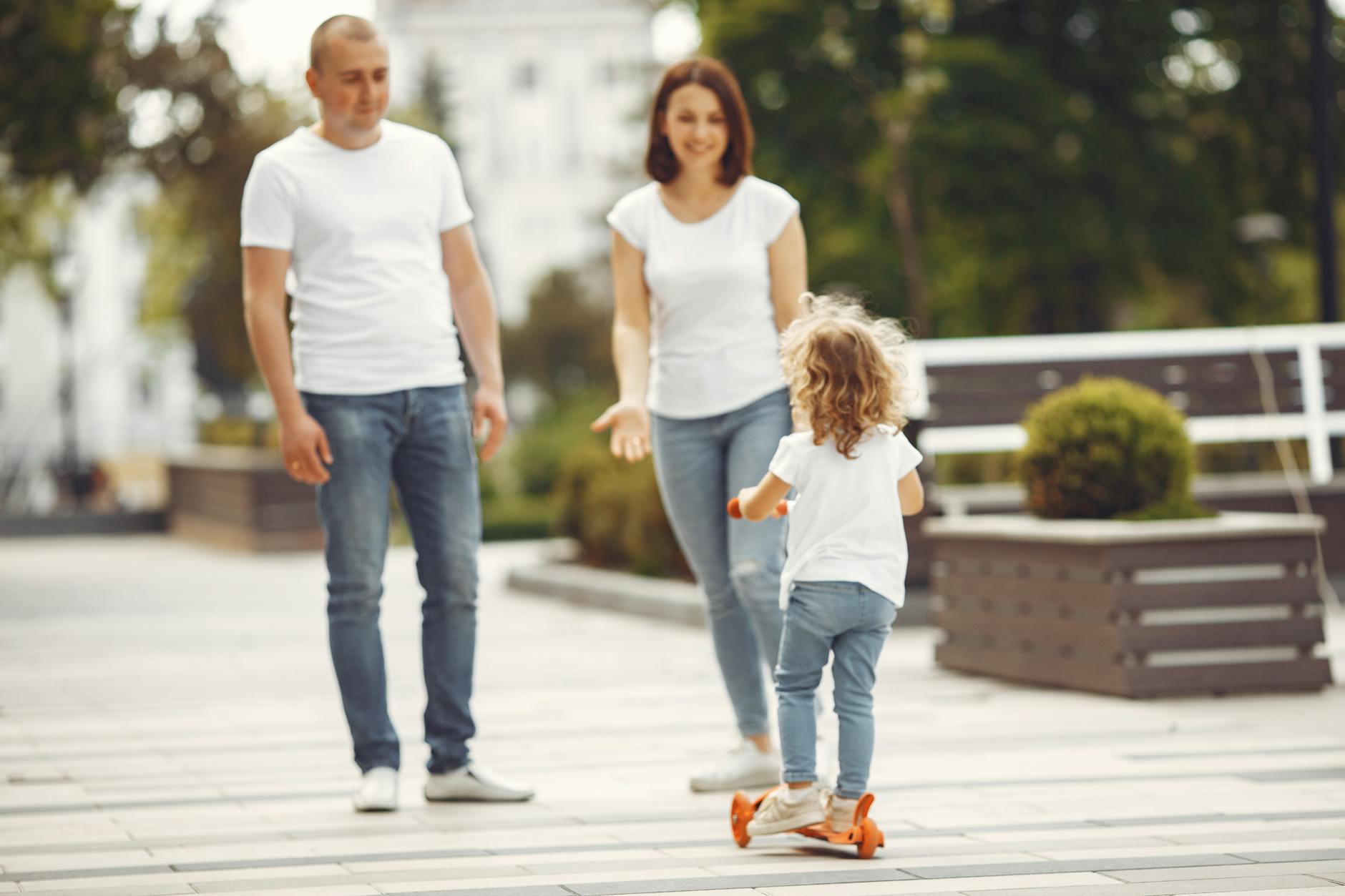 Happy family spending quality time together outdoors, with a child riding a skateboard. - co-parenting after divorce