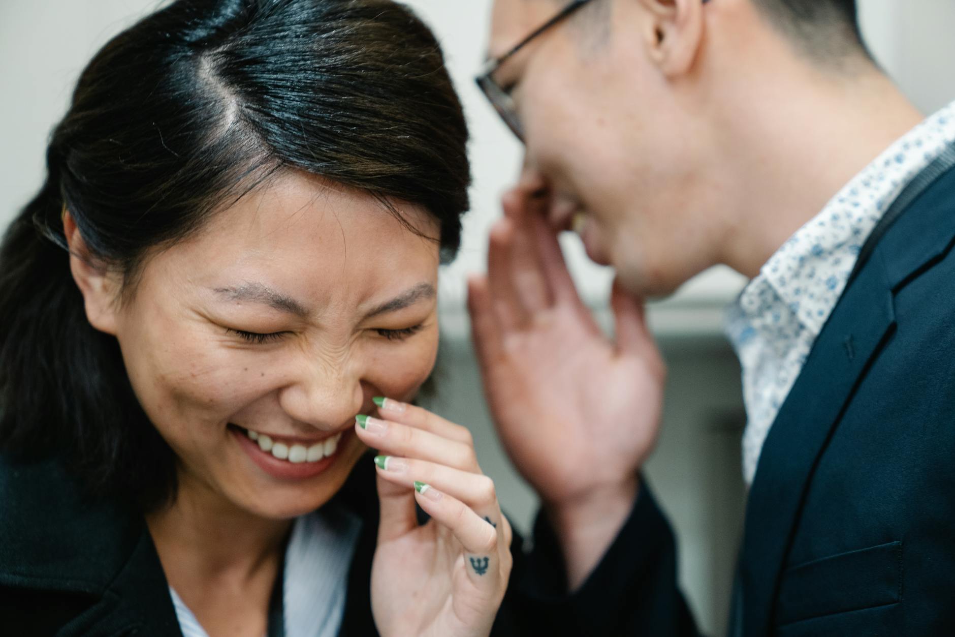 Close-up of a joyful interaction with laughter and whispering. - communicate needs relationship