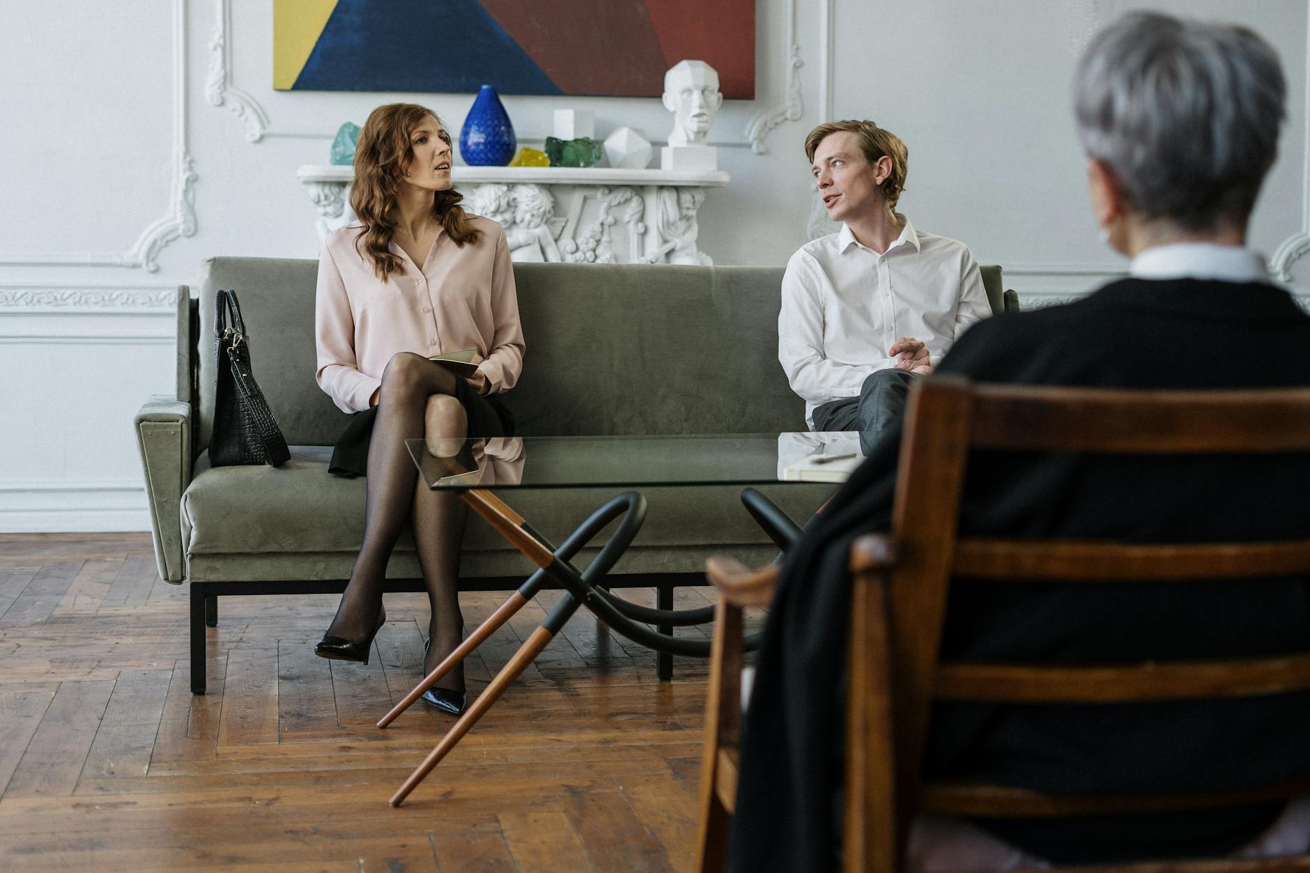 A couple having a discussion with a counselor in a modern office setting. - couples counseling benefits