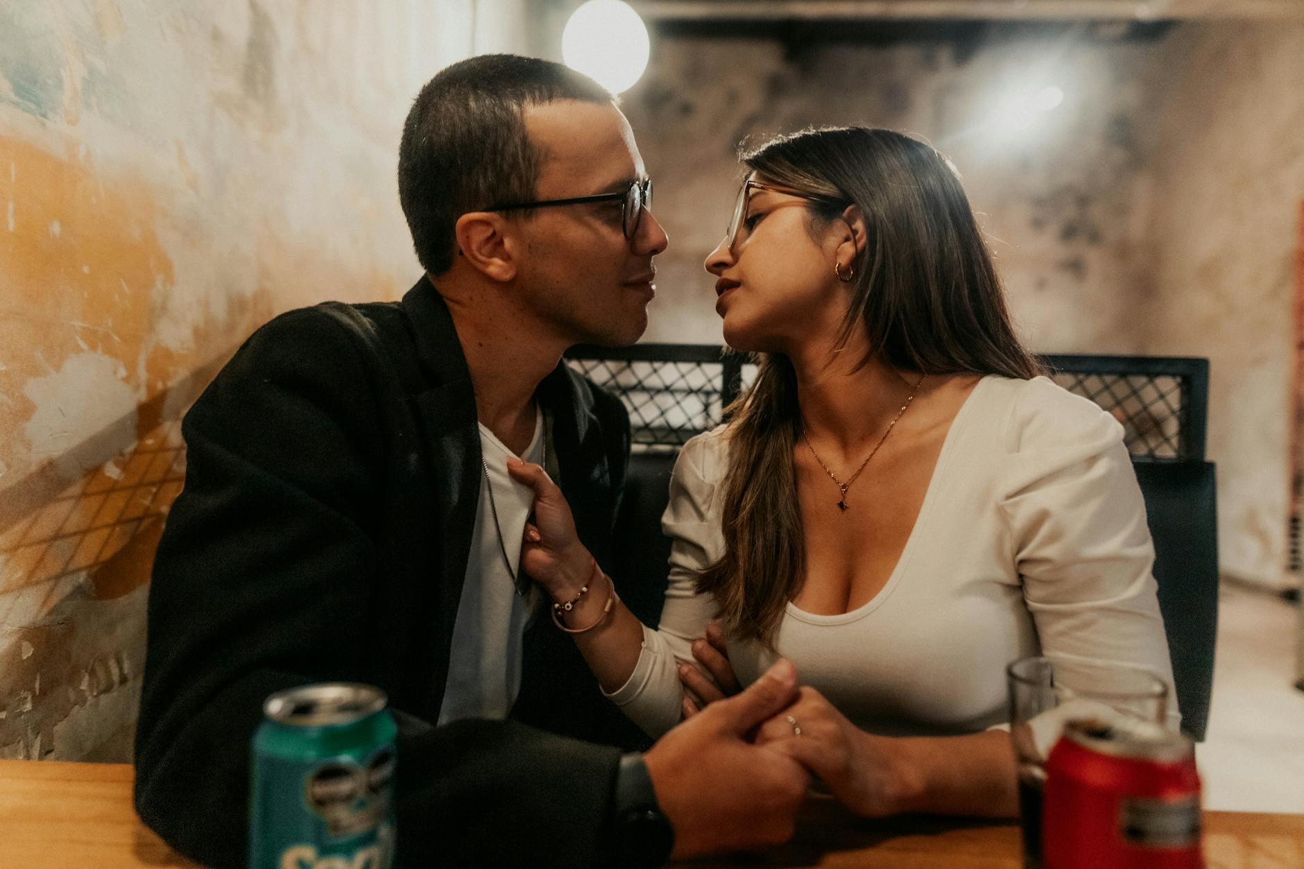 A couple sharing an intimate moment in a cozy Buenos Aires cafe, capturing love. - dating over 40