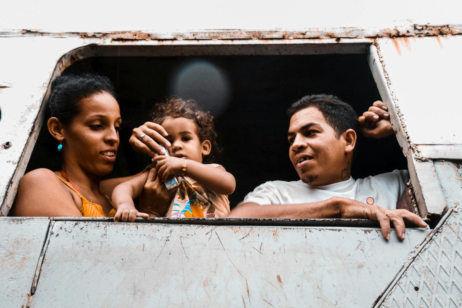 Happy family looking out a window, capturing a moment of connection and joy. - express needs family