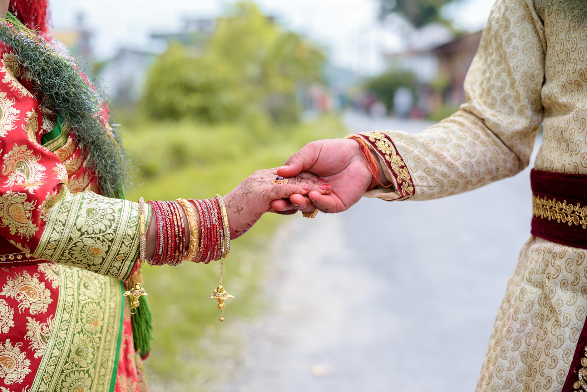 A couple holding hands in traditional Indian attire, symbolizing love and unity. - marriage connection rituals