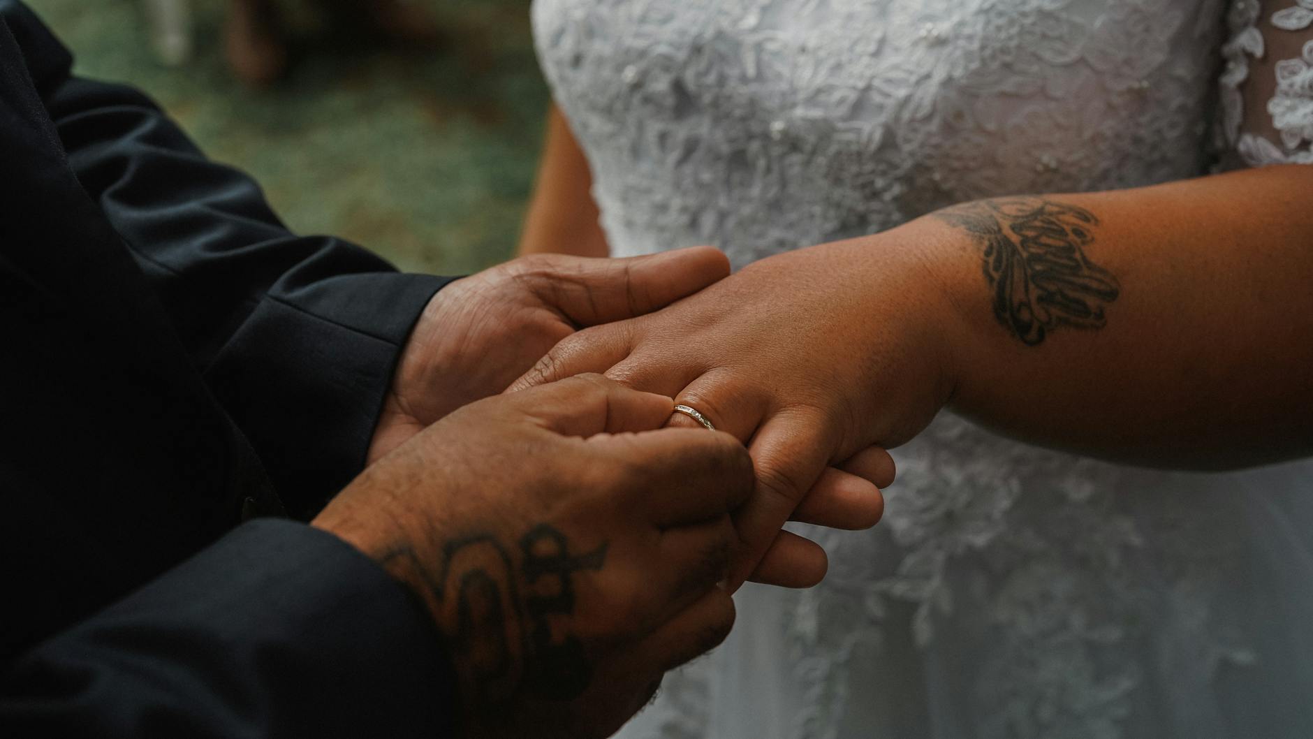 Close-up of a couple exchanging rings during a wedding ceremony, symbolizing love. - marriage connection rituals