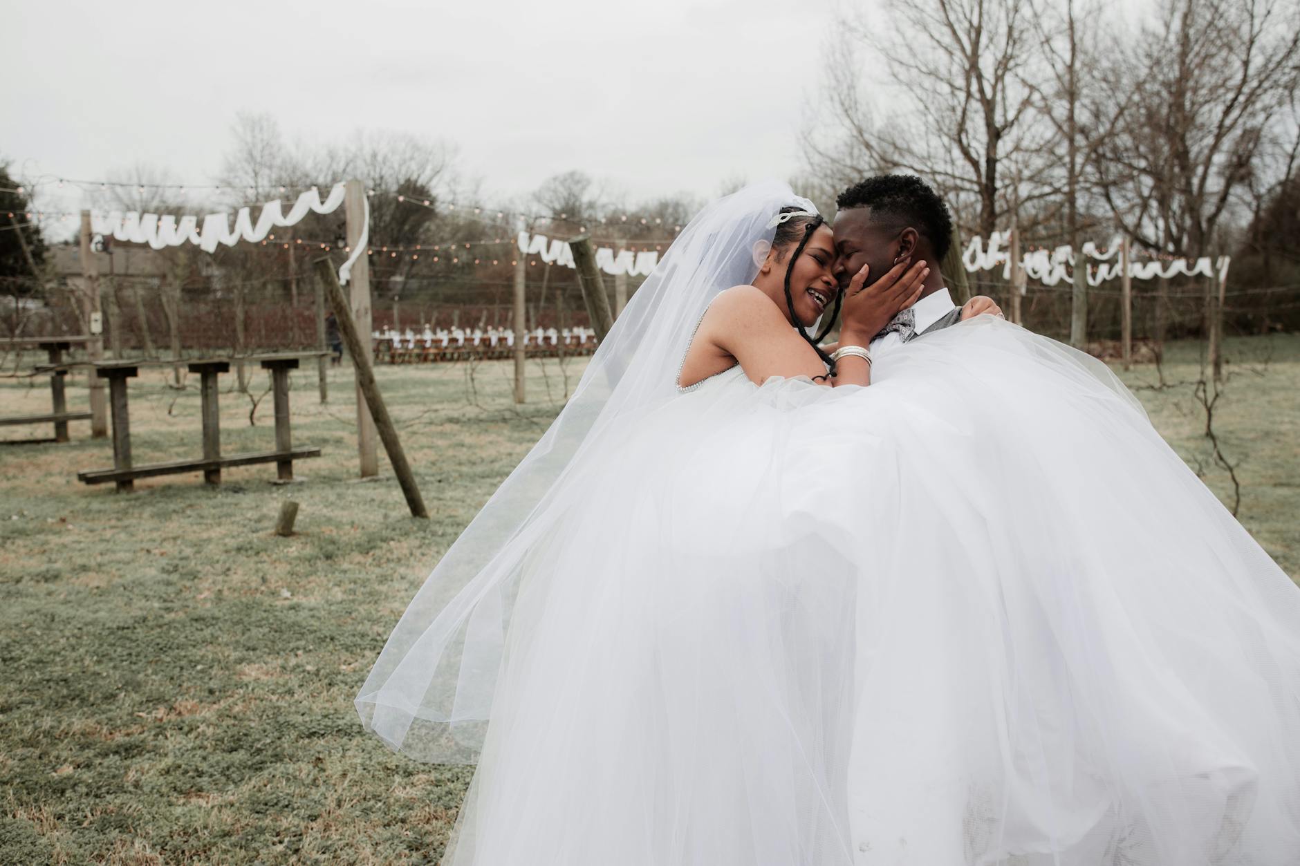 Happy newlywed couple embracing in outdoor wedding setting, conveying love and joy. - marriage goals spring