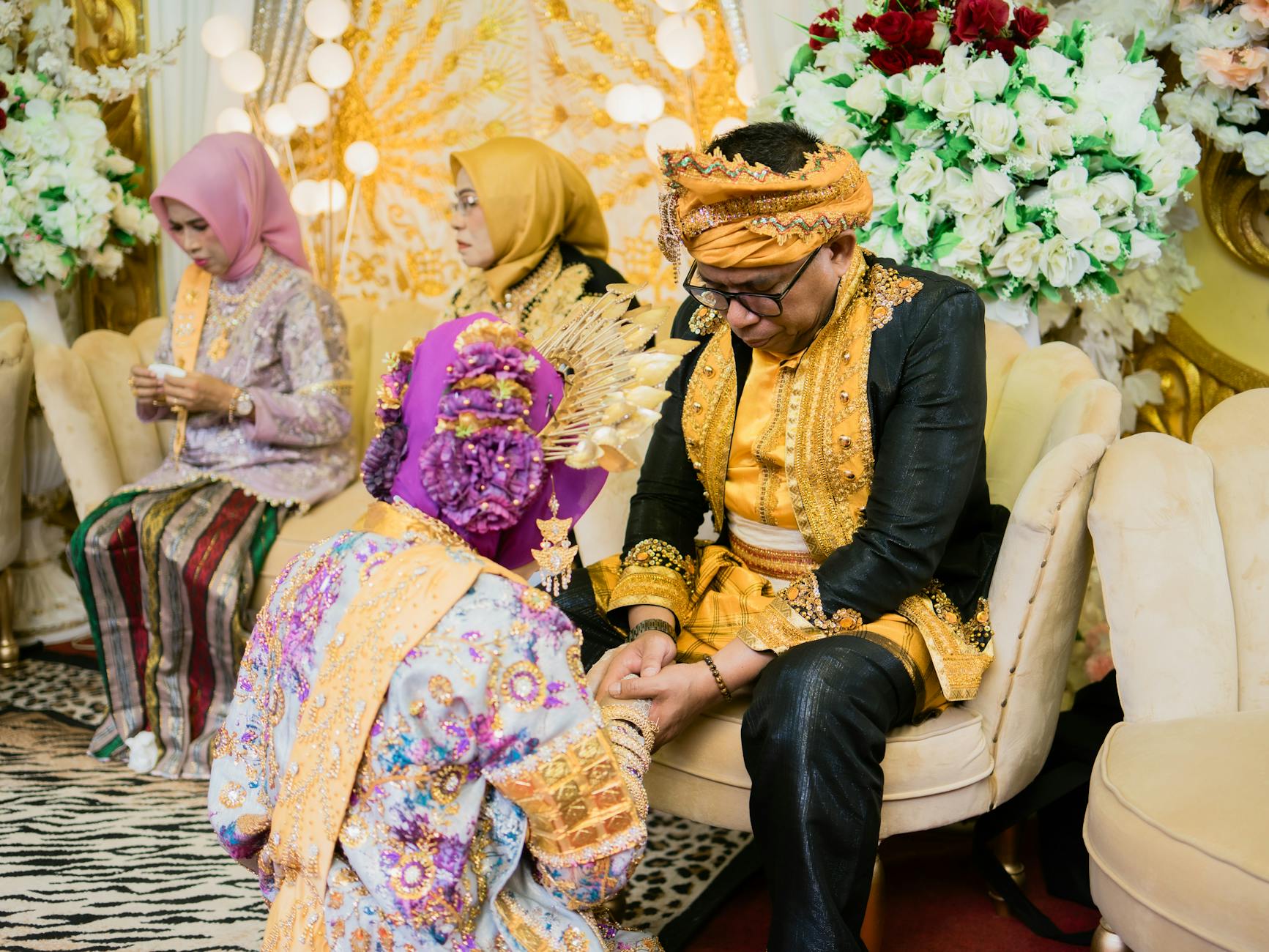 A vibrant traditional wedding ceremony taking place indoors in Kendari, Indonesia. - marriage traditions