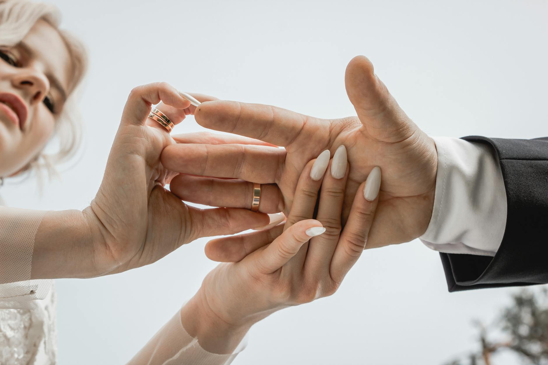 Intimate close-up of a couple exchanging rings at their wedding ceremony. - marriage tune up