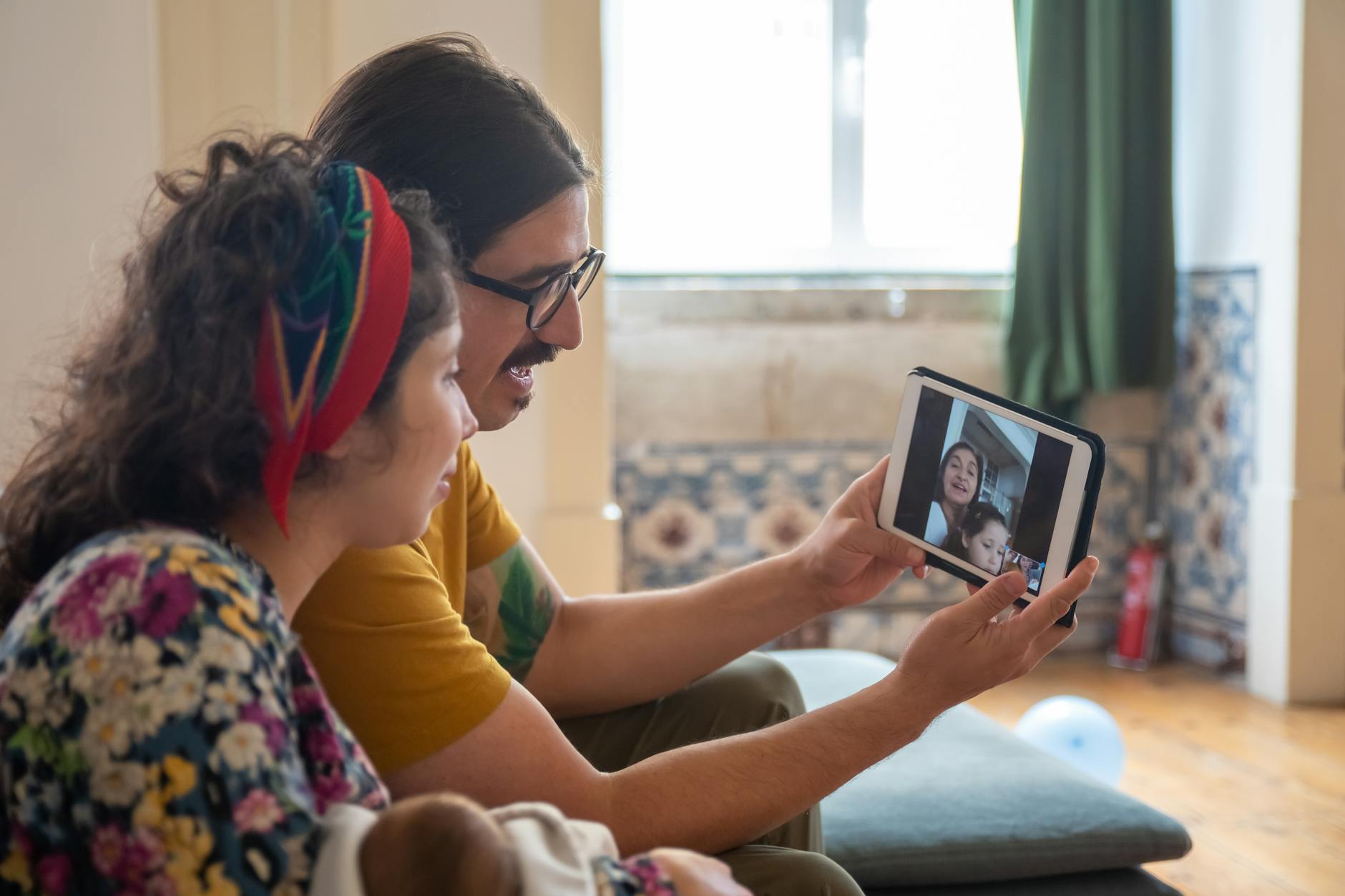 A family enjoys a video call at home in Portugal, sharing joyful moments together. - partner communication family