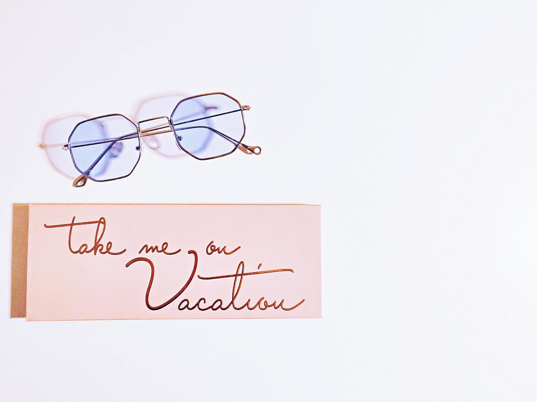 Minimalist image featuring eyeglasses and a 'Vacation' card, perfect for travel themes. - post vacation blues