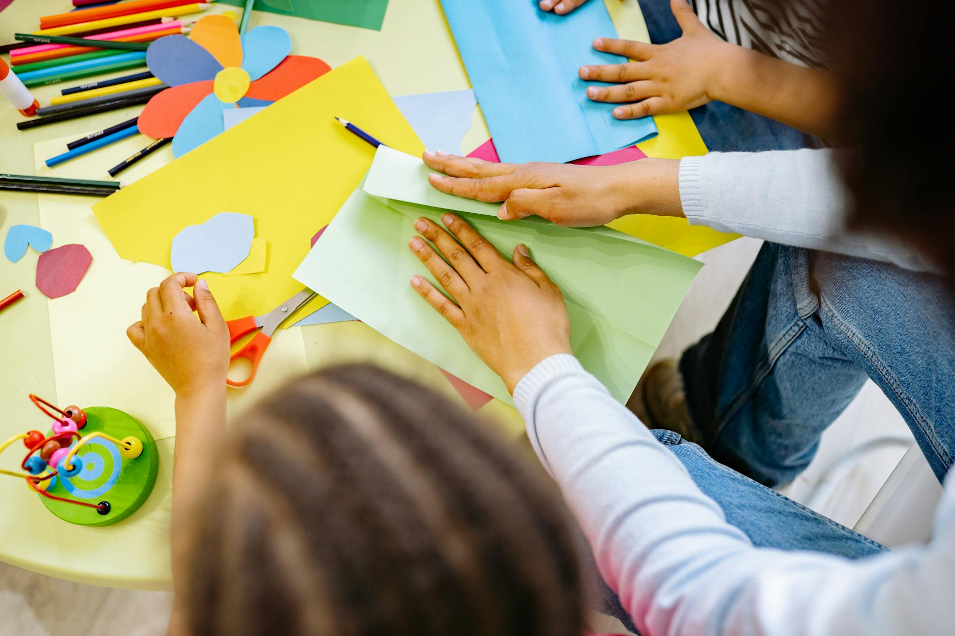 Kids crafting with colorful paper and materials in a creative classroom setting. - preschool spring activities