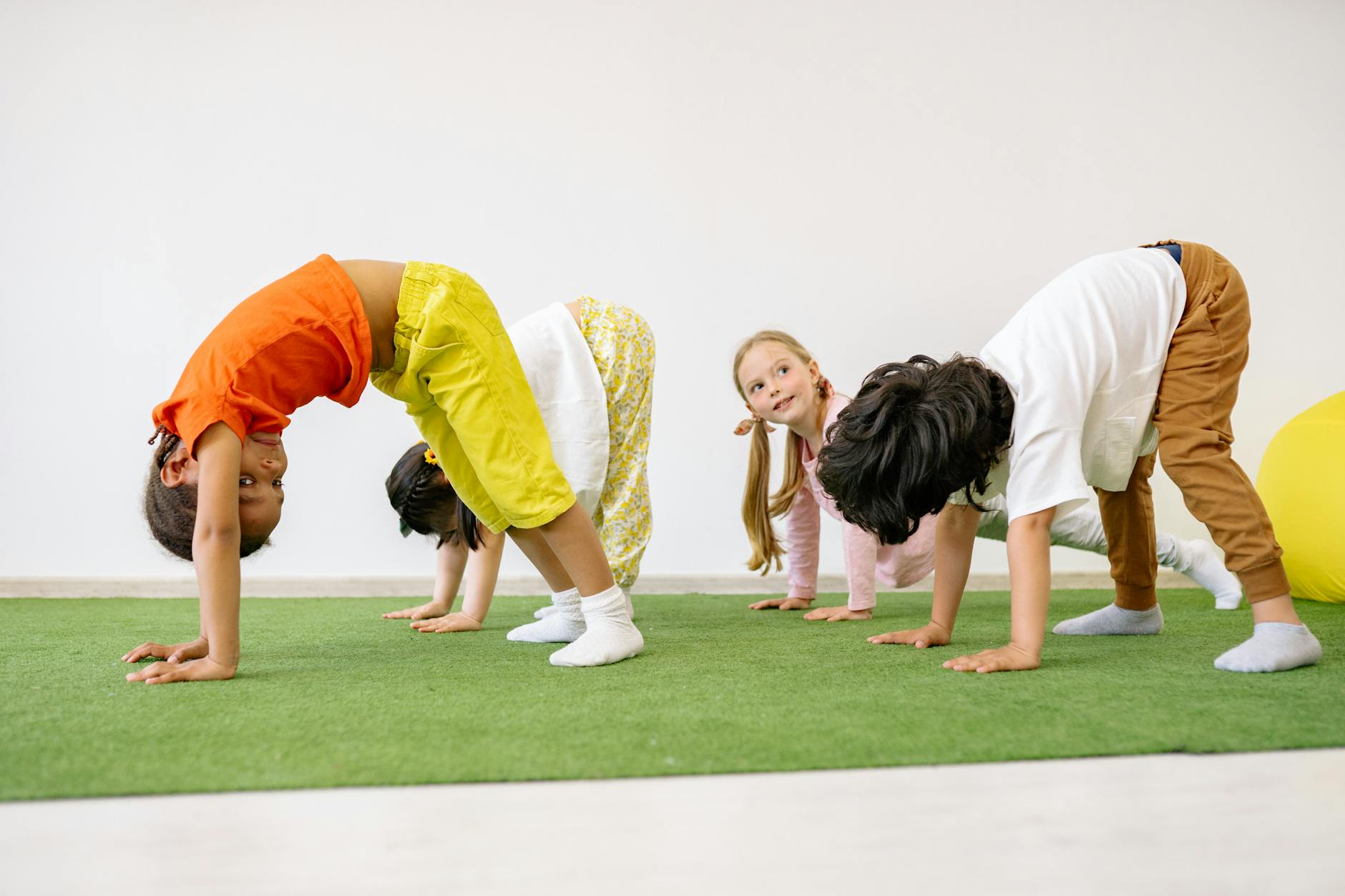 Happy children engaging in playful exercise and learning indoors, fostering group togetherness. - preschool spring schedule