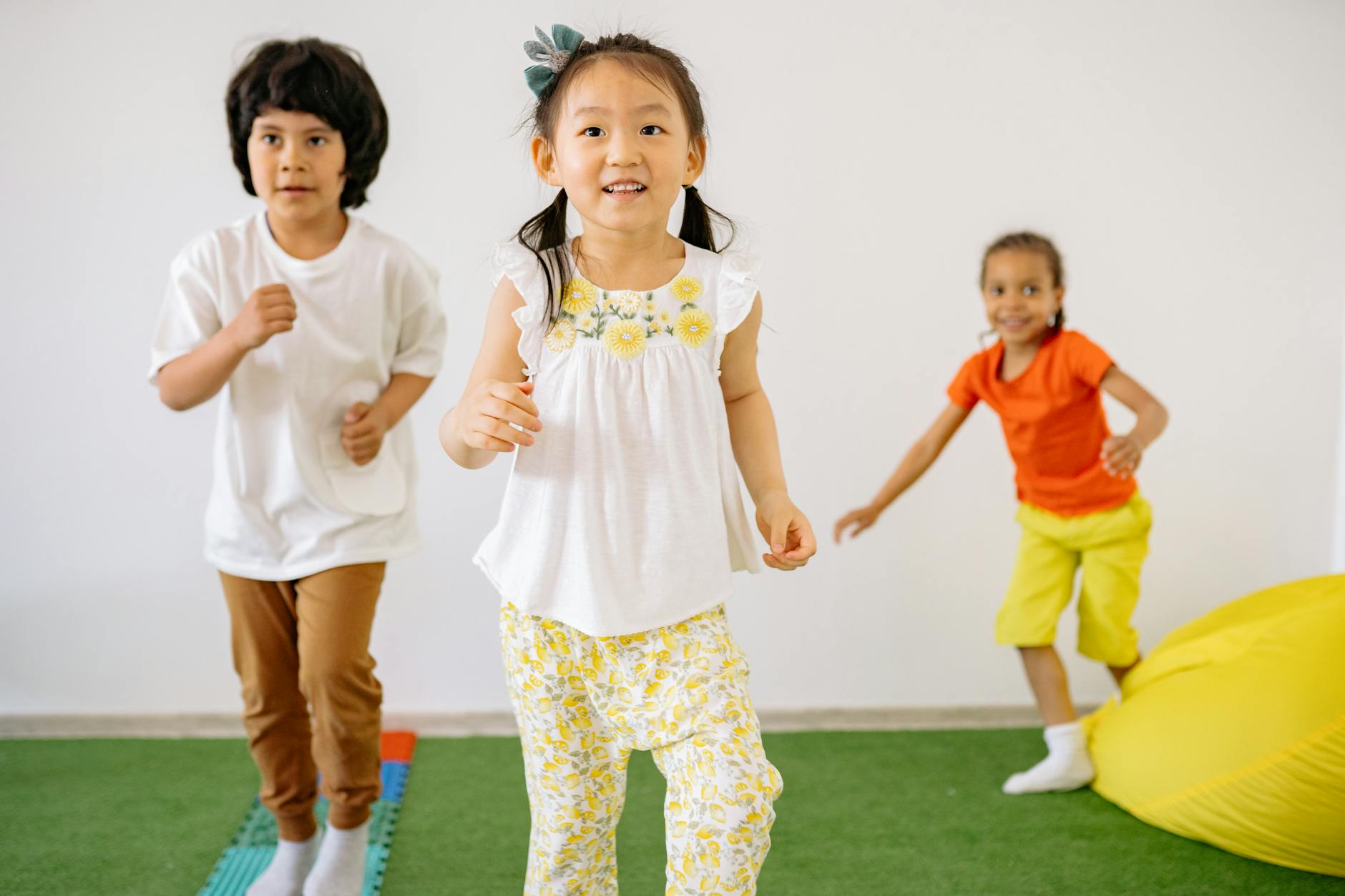Group of happy diverse children playing indoors, enjoying fun and friendship in a colorful kindergarten setting. - preschool spring schedule