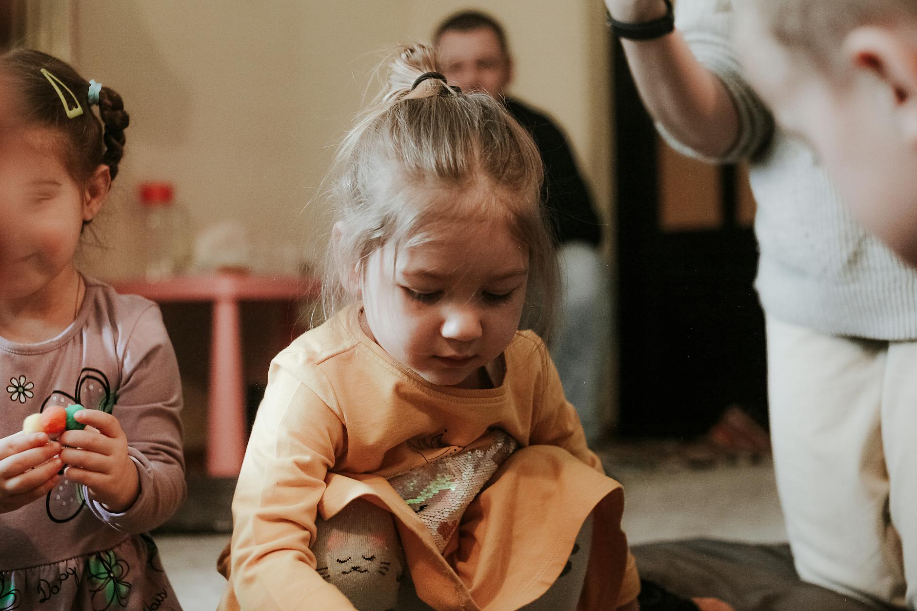 Young children engaged in play indoors, focused on creative activities - preschooler spring adjustment