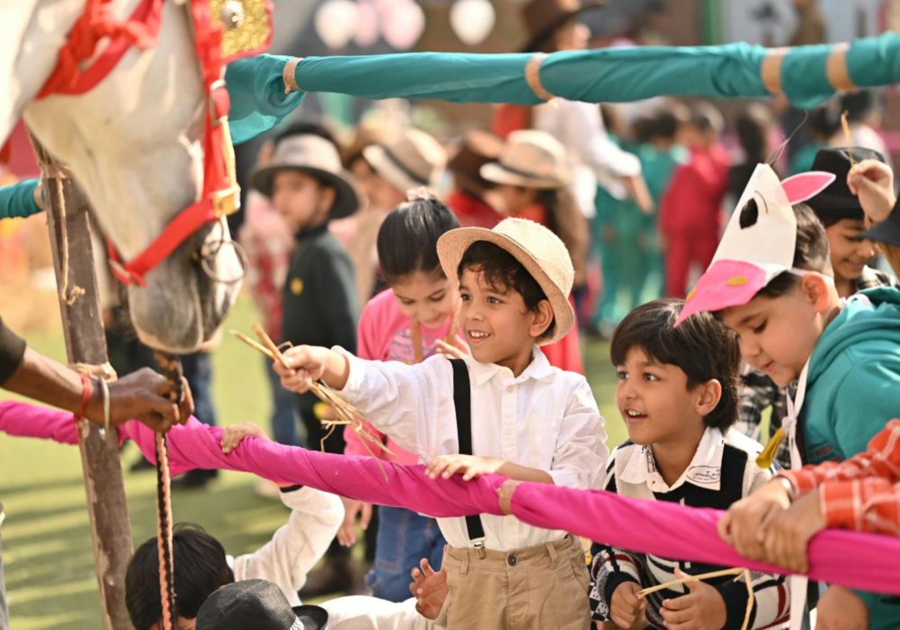 Kids interact with a horse during a lively play school event in India. - preschooler spring play