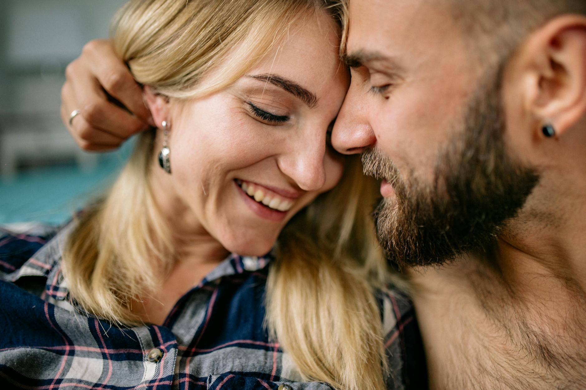 A warm, intimate moment between a smiling couple indoors - reconnect with partner