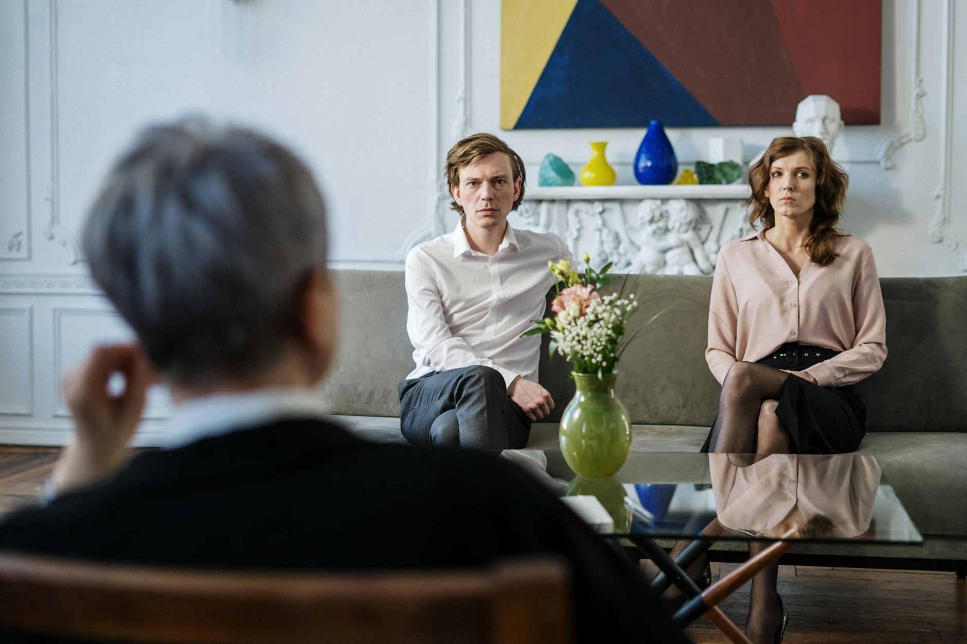 A couple consulting with a therapist in a modern studio setting. - relationship renewal therapy