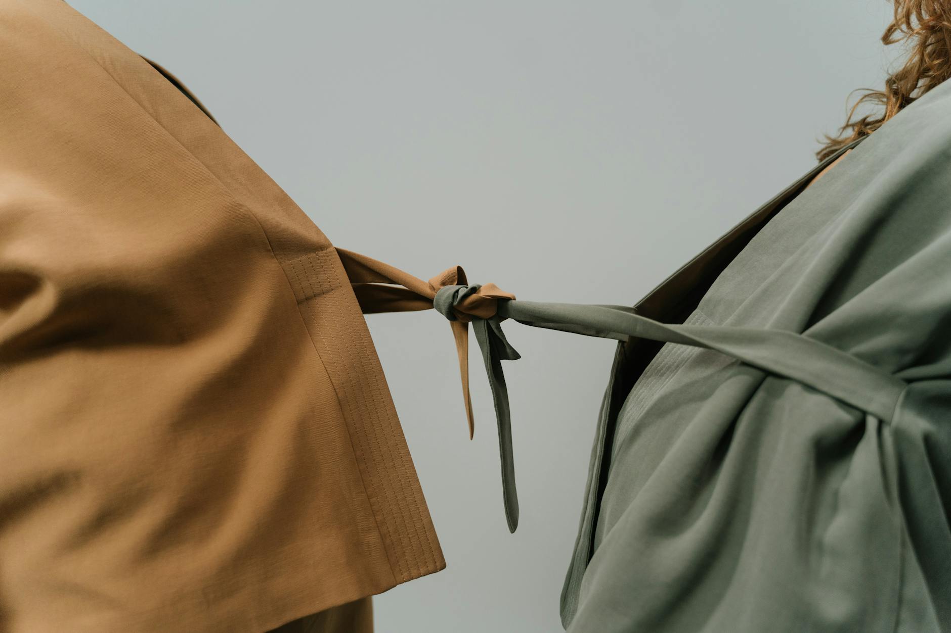 Close-up of two blazers tied together representing connection and unity. - release relationship resentments