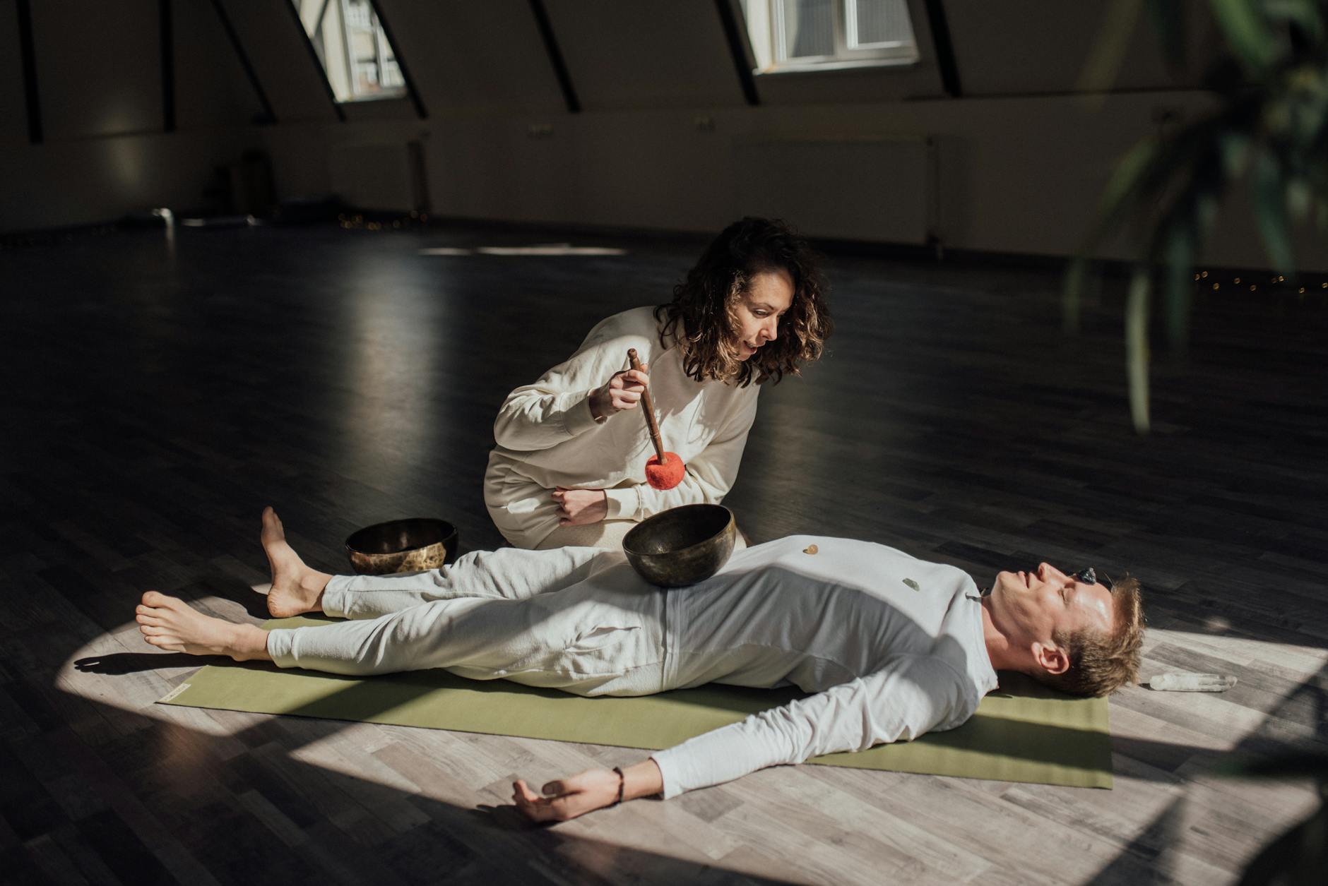 A soothing indoor sound bath session with Tibetan singing bowls promoting relaxation and healing. - somatic healing