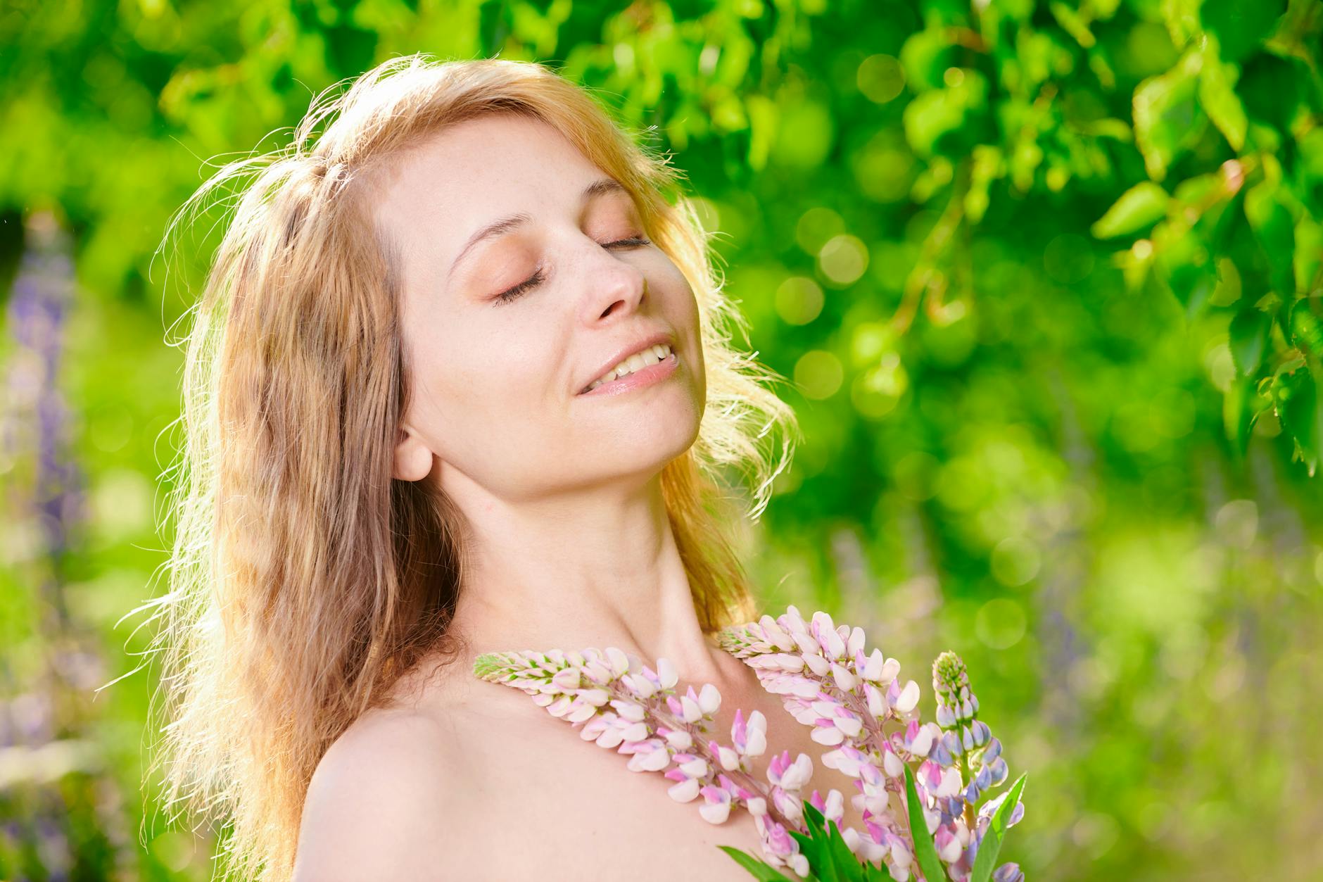 A peaceful woman enjoying a sunny day in a vibrant green garden, holding flowers. - spring allergy anxiety