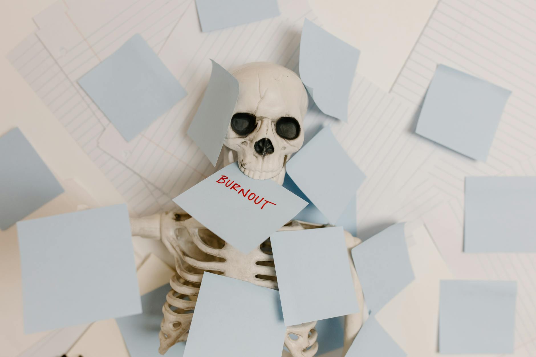 A skeleton covered in sticky notes with 'burnout' on one, symbolizing work stress and exhaustion. - spring burnout recovery