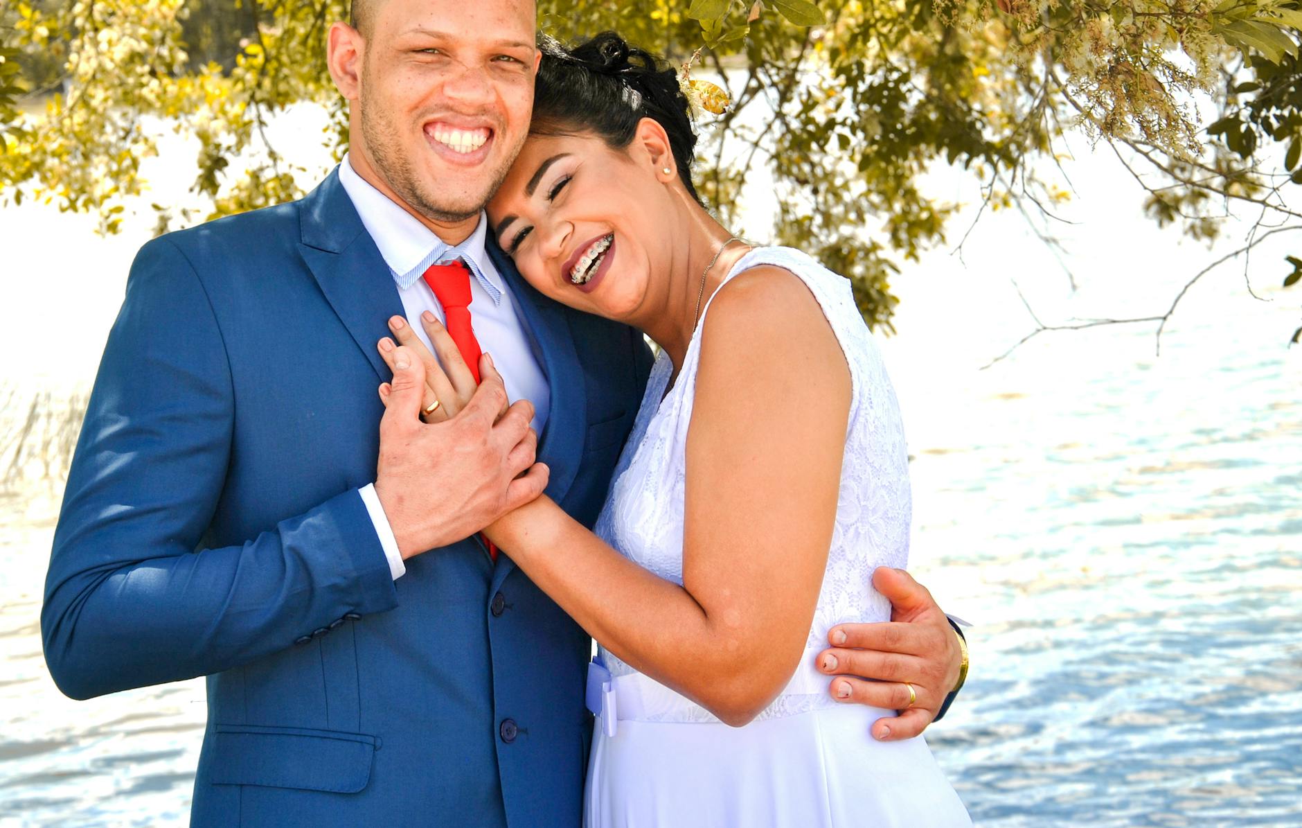 Smiling newlywed couple in nature enjoying a happy moment together. - spring marriage joy