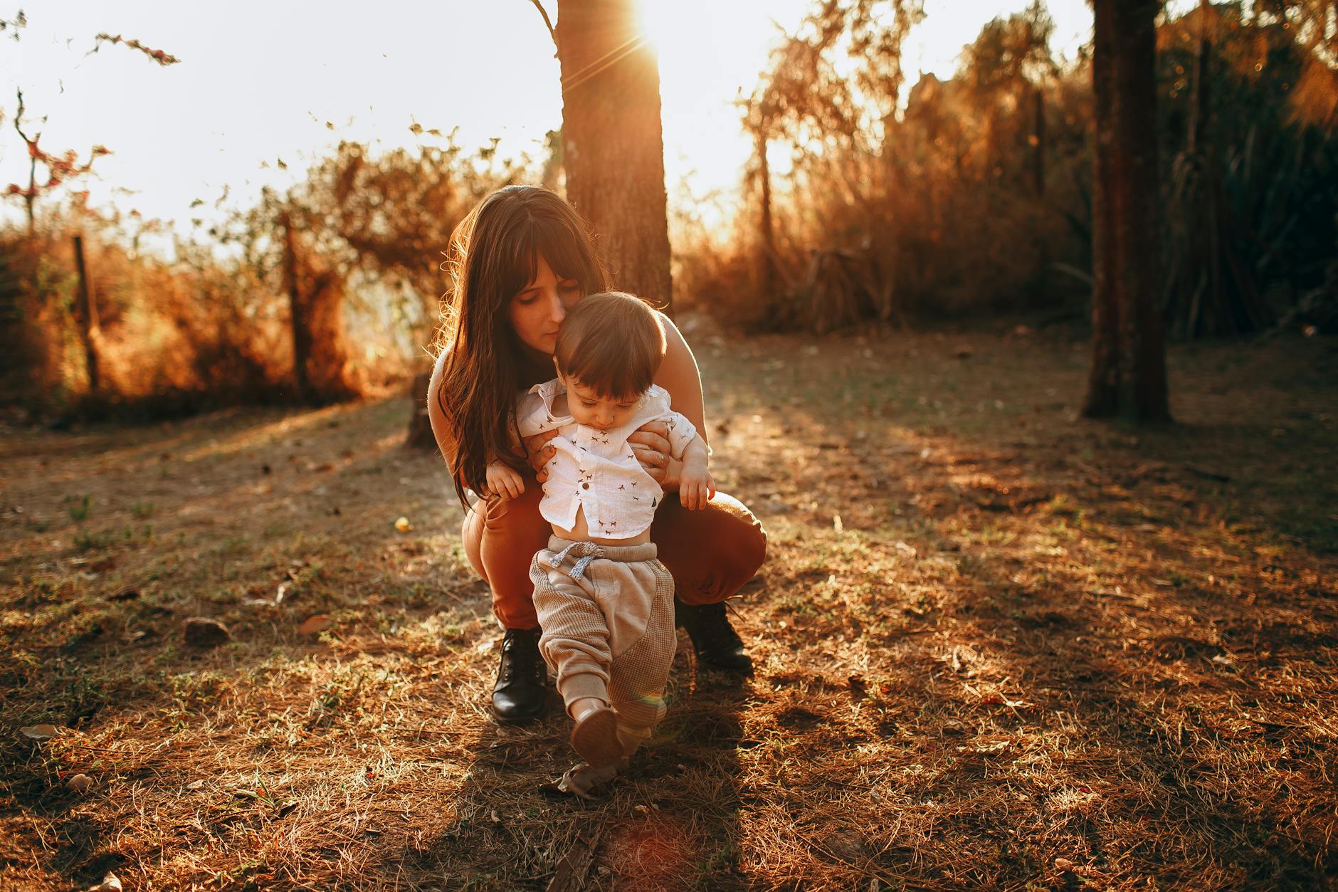Full body of adorable little boy walking in garden with help of mother in summer - toddler growth spurts