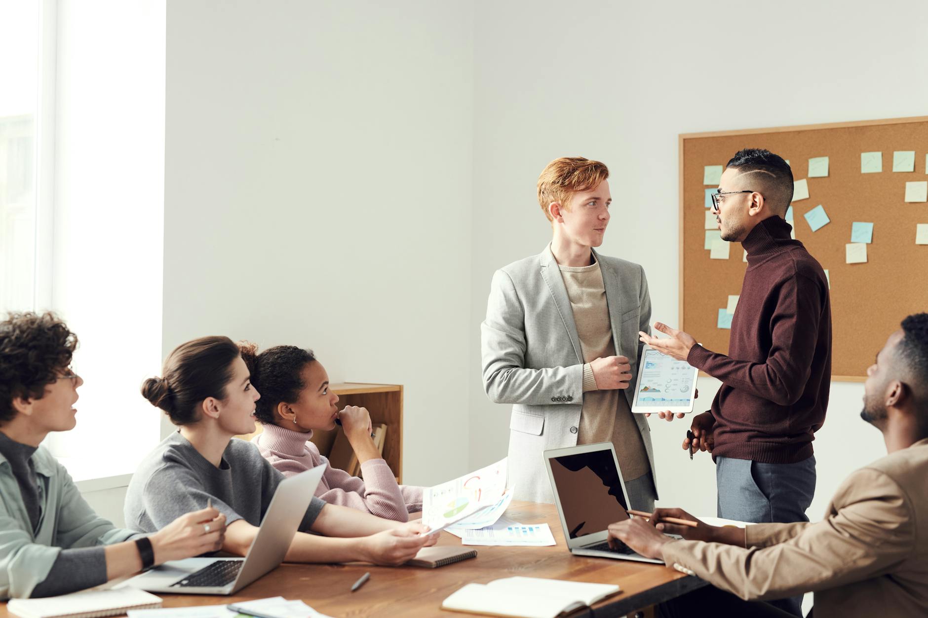 A group of professionals collaborating in a modern office meeting room, exchanging ideas. - coparenting communication strategies