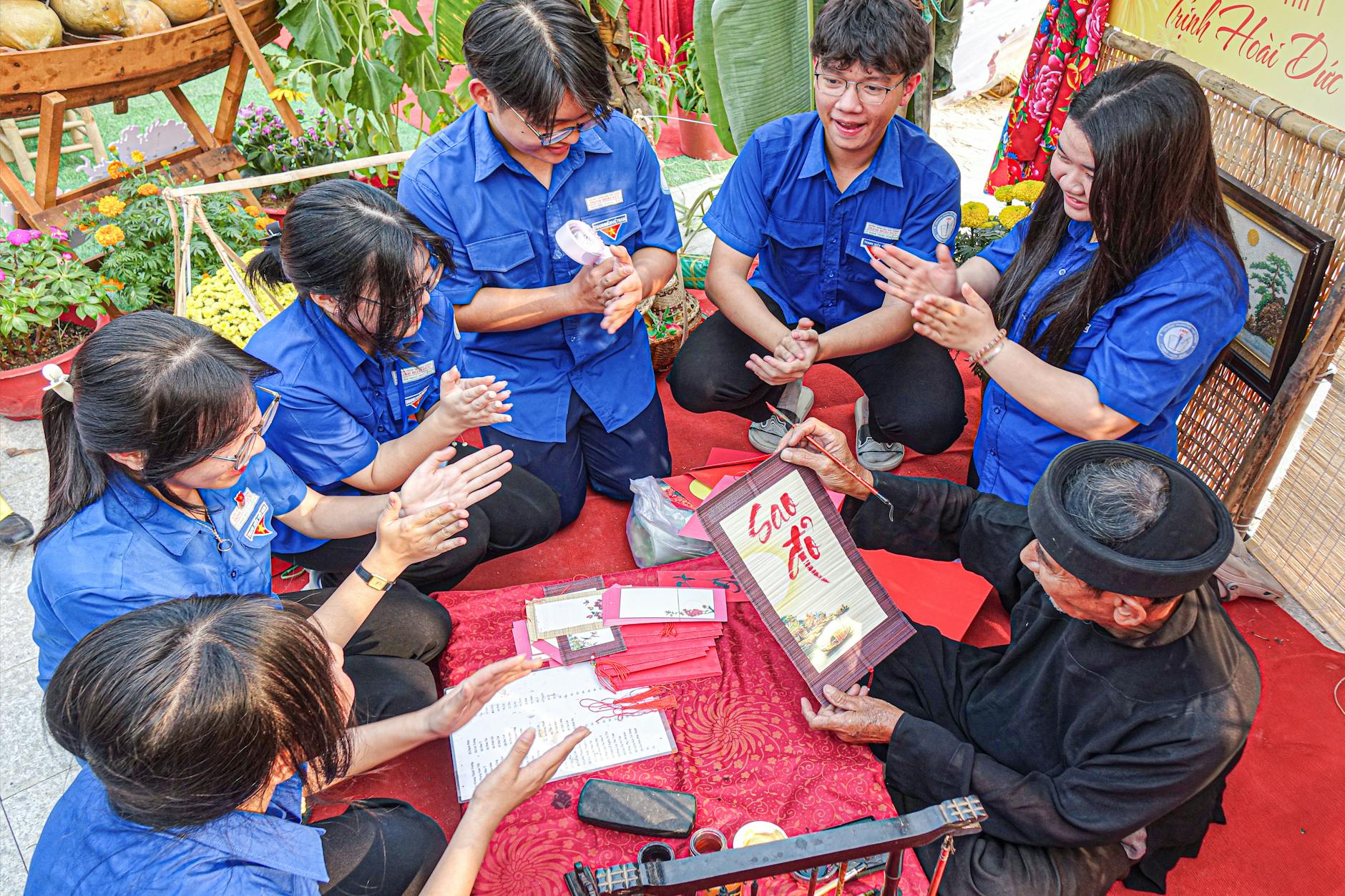 Young adults participating in a traditional art session, guided by an elder, highlighting cultural exchange. - dbt skills spring