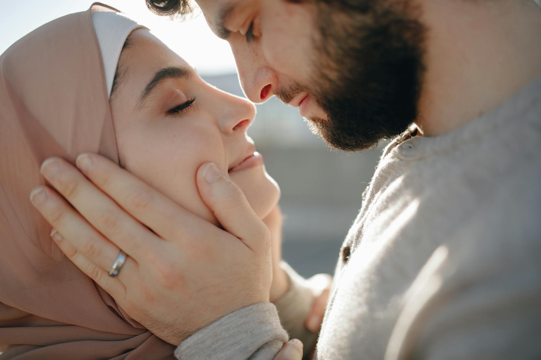 A couple shares an intimate moment outdoors, embracing tenderly. - deep couple communication
