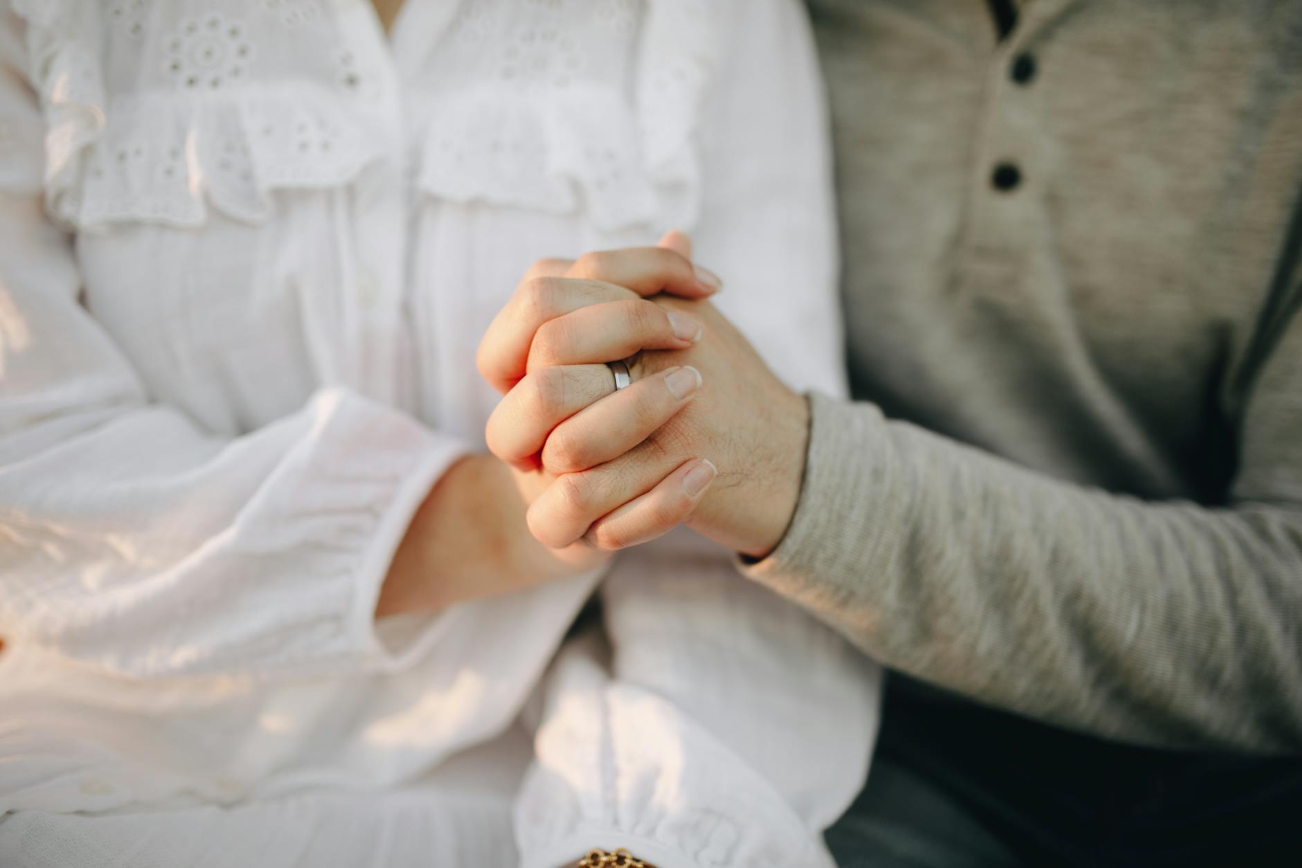 Close-up of a couple holding hands, symbolizing love and connection. - deepen marriage connection