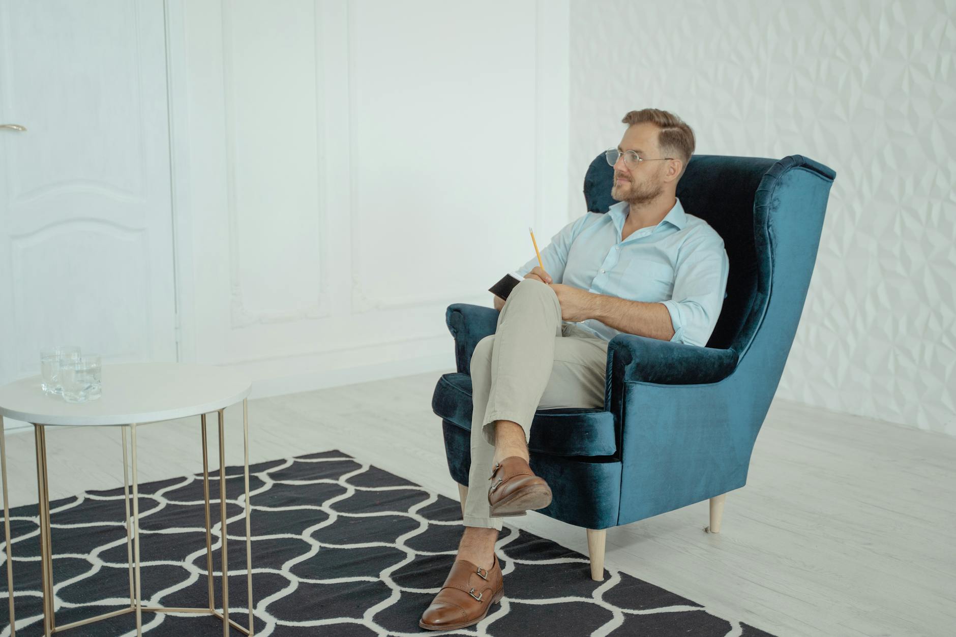 A psychologist attentively listening and taking notes in a calm office setting. - imposter syndrome therapy