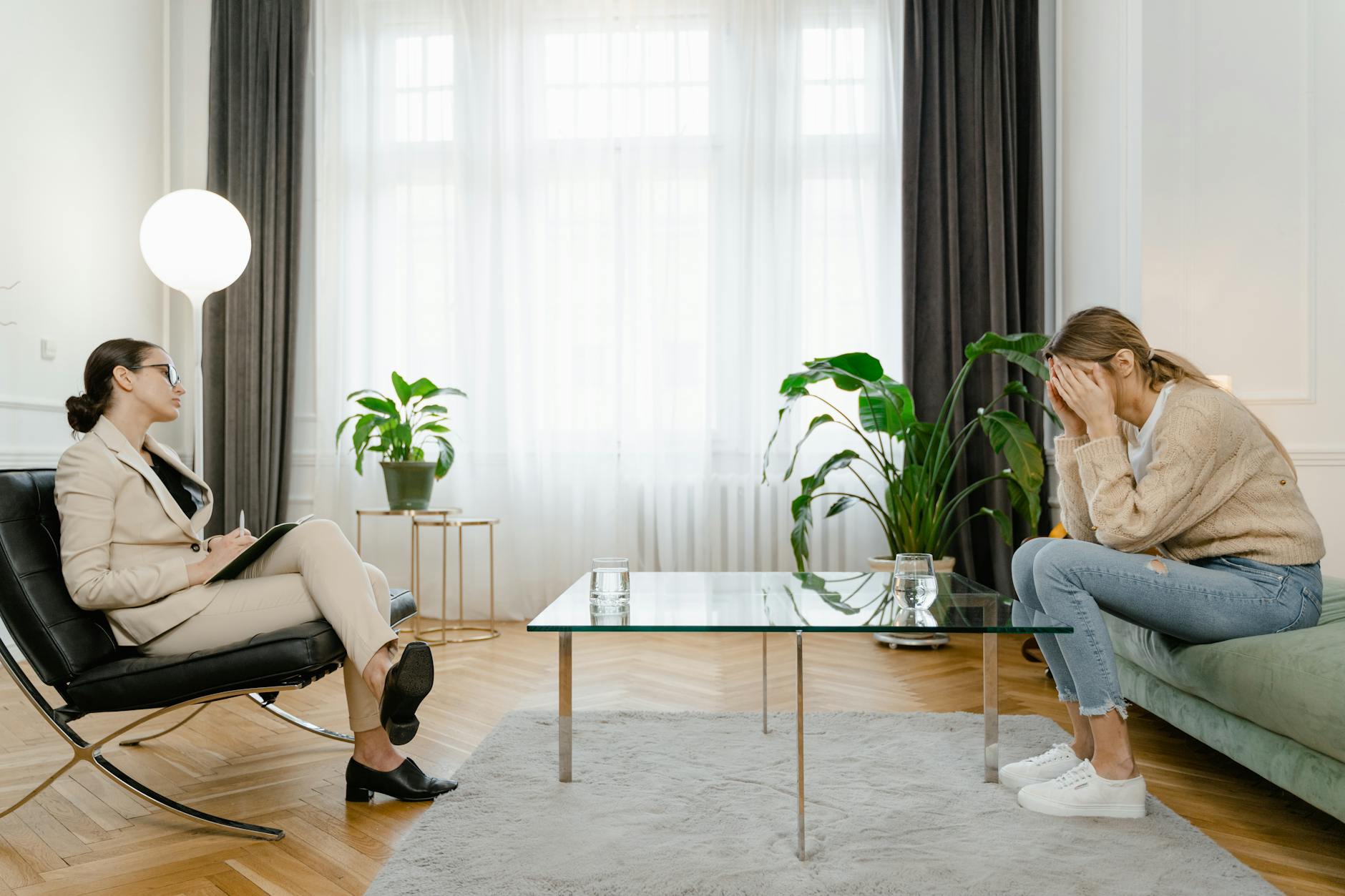A therapist and a client in a modern office setting during a counseling session. - imposter syndrome therapy