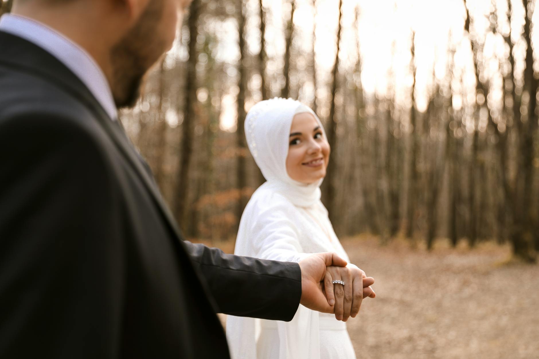 A captivating outdoor wedding portrait of a happy couple holding hands, radiating romance in nature. - marriage plateau